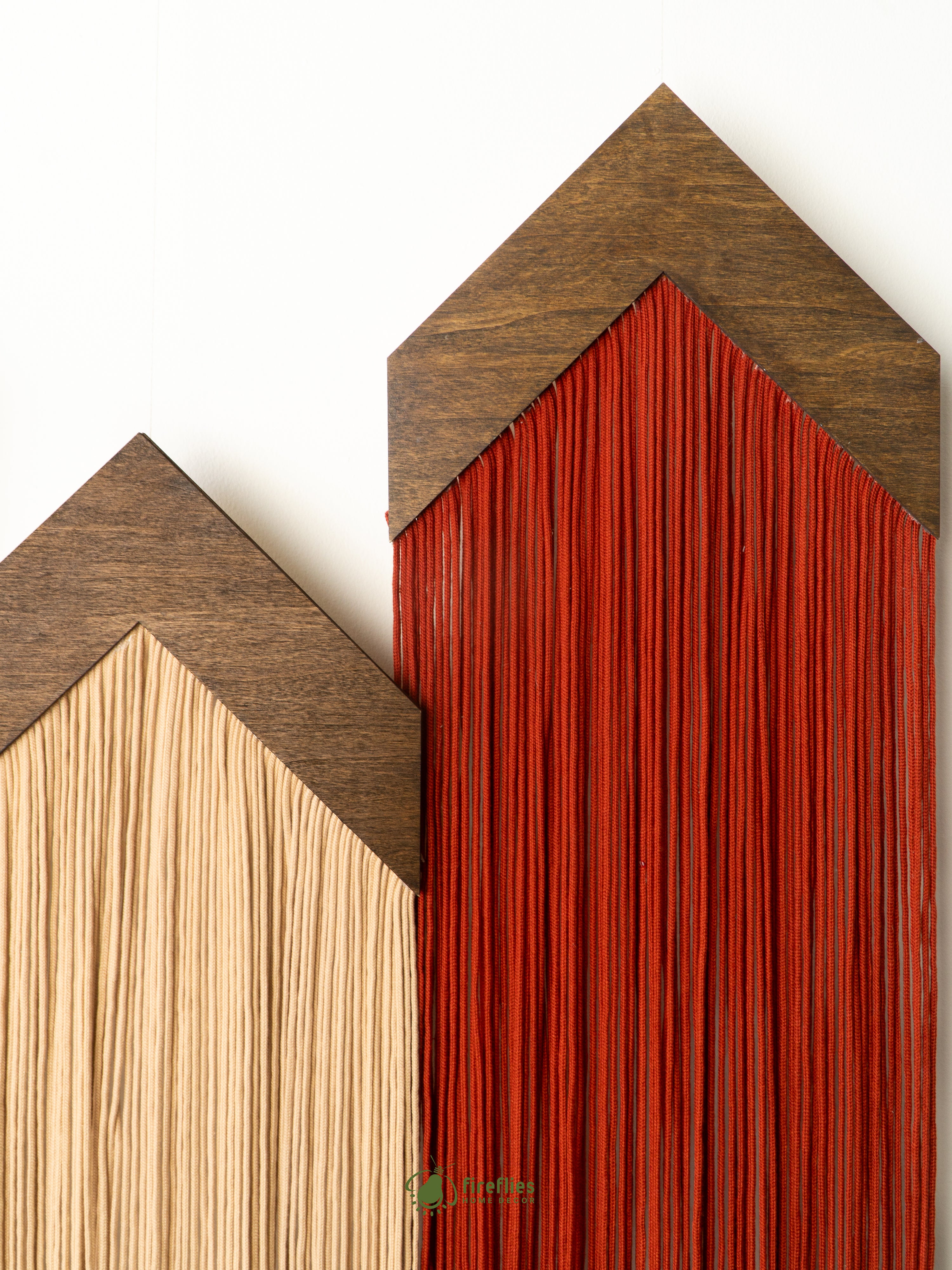 Two wooden house-shaped shelves with different finishes on a white background