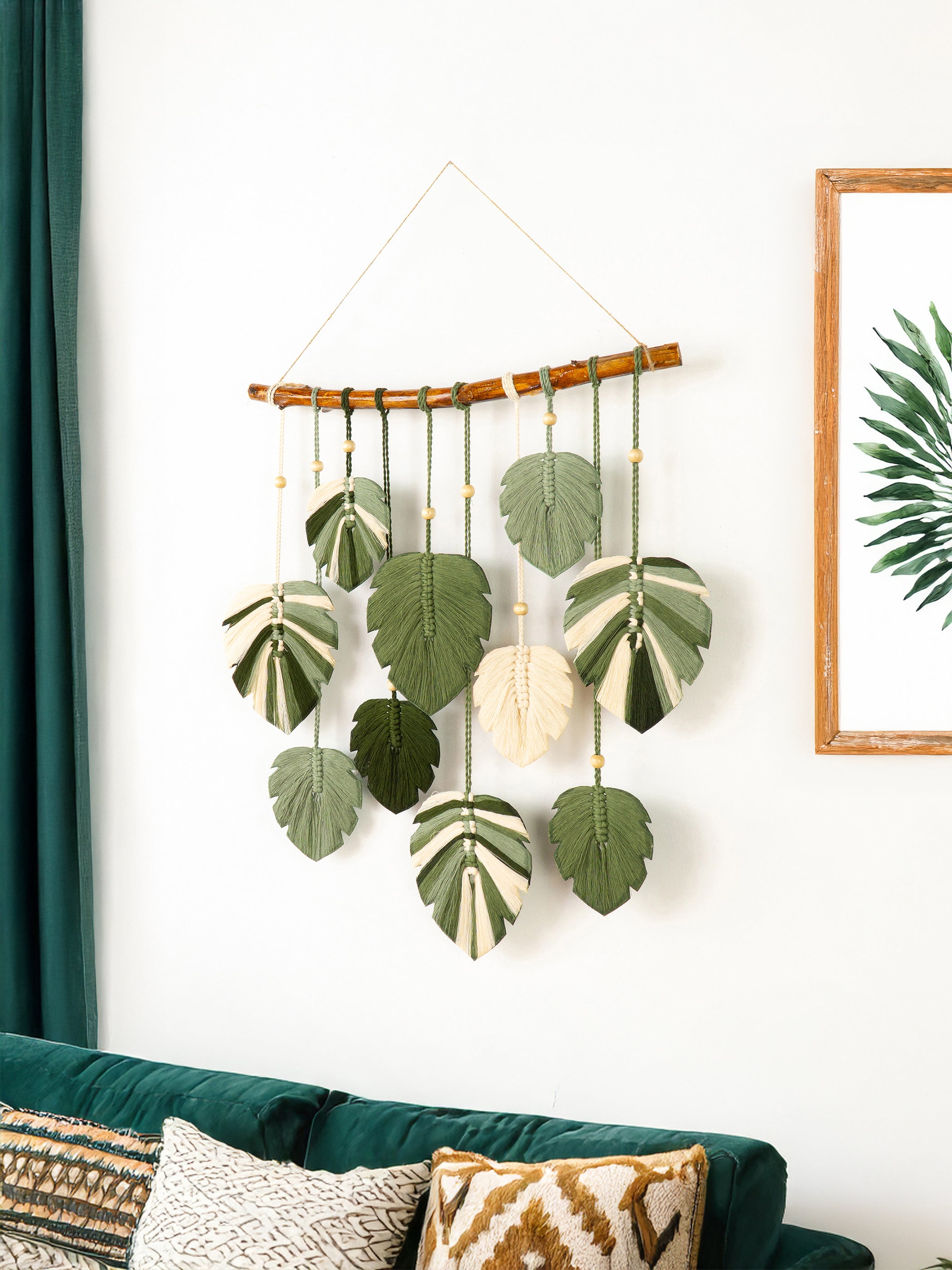 Macrame wall hanging with leaves on a white wall
