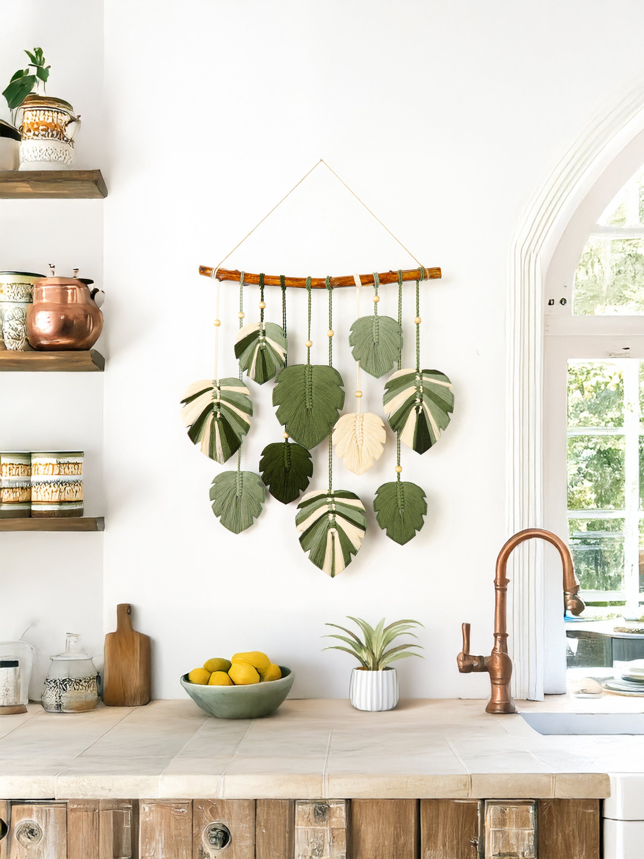 Decorative wall hanging with green leaves in a bedroom setting