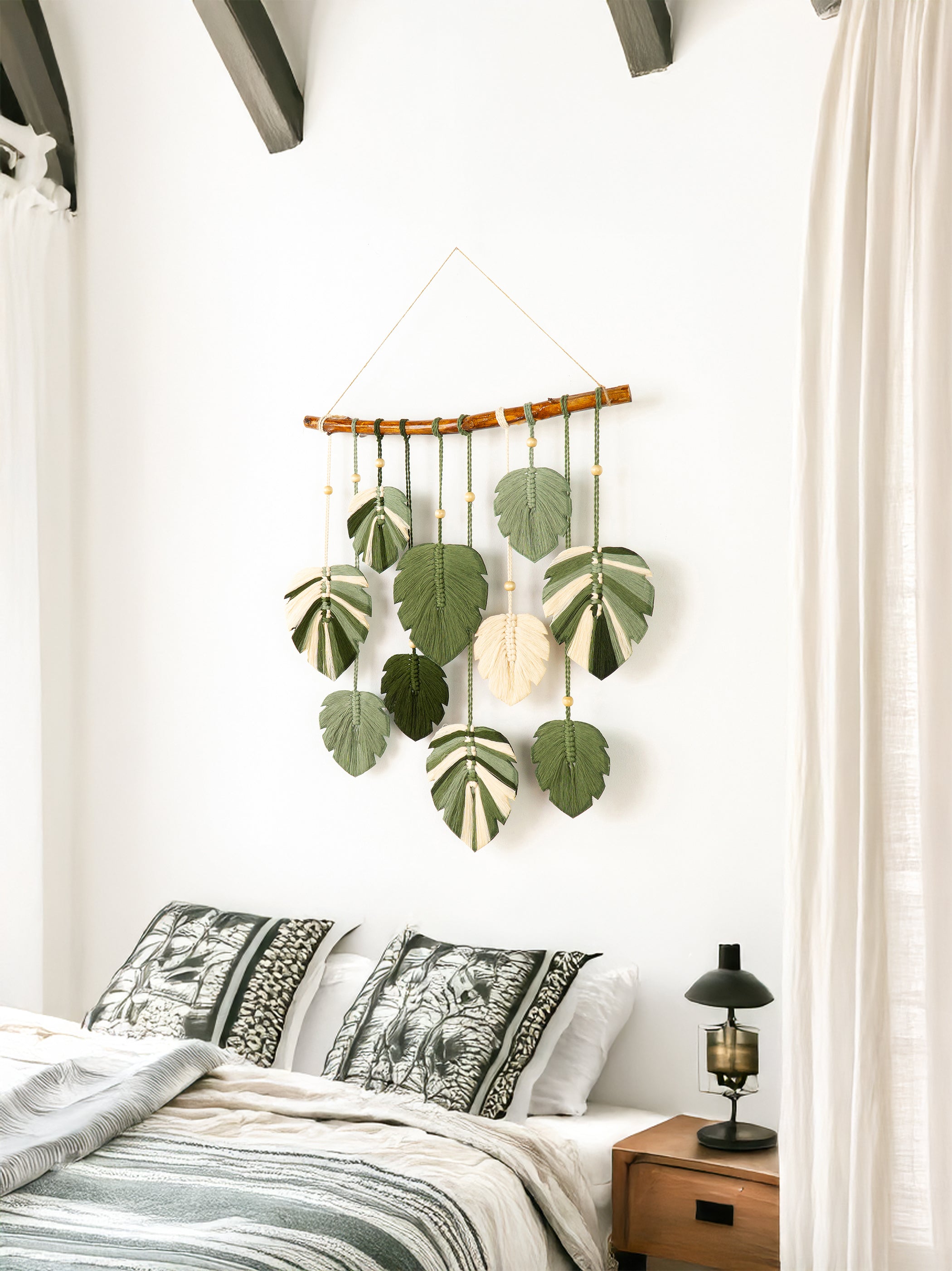 Bathroom interior with a macrame wall hanging, shelves, and green tiles.