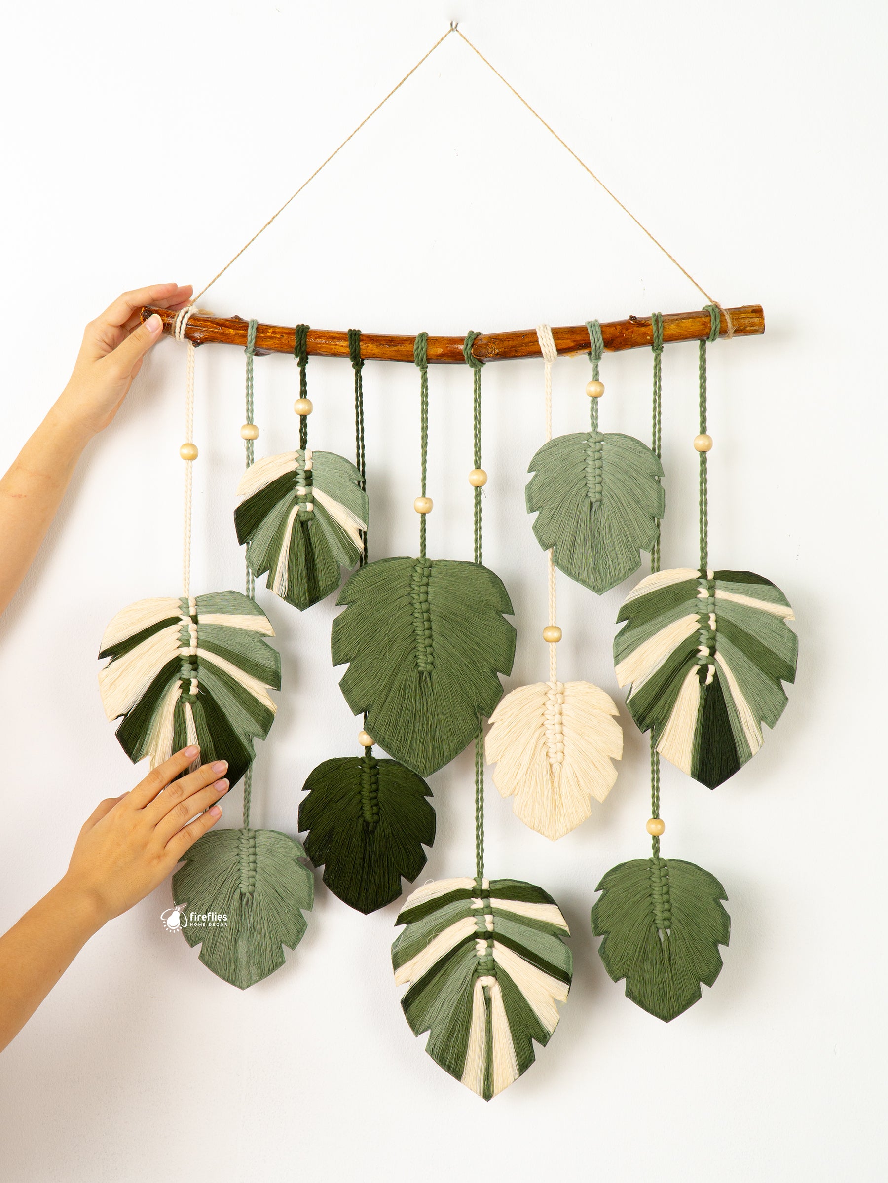 Decorative wall hanging with leaf-shaped ornaments on a white background