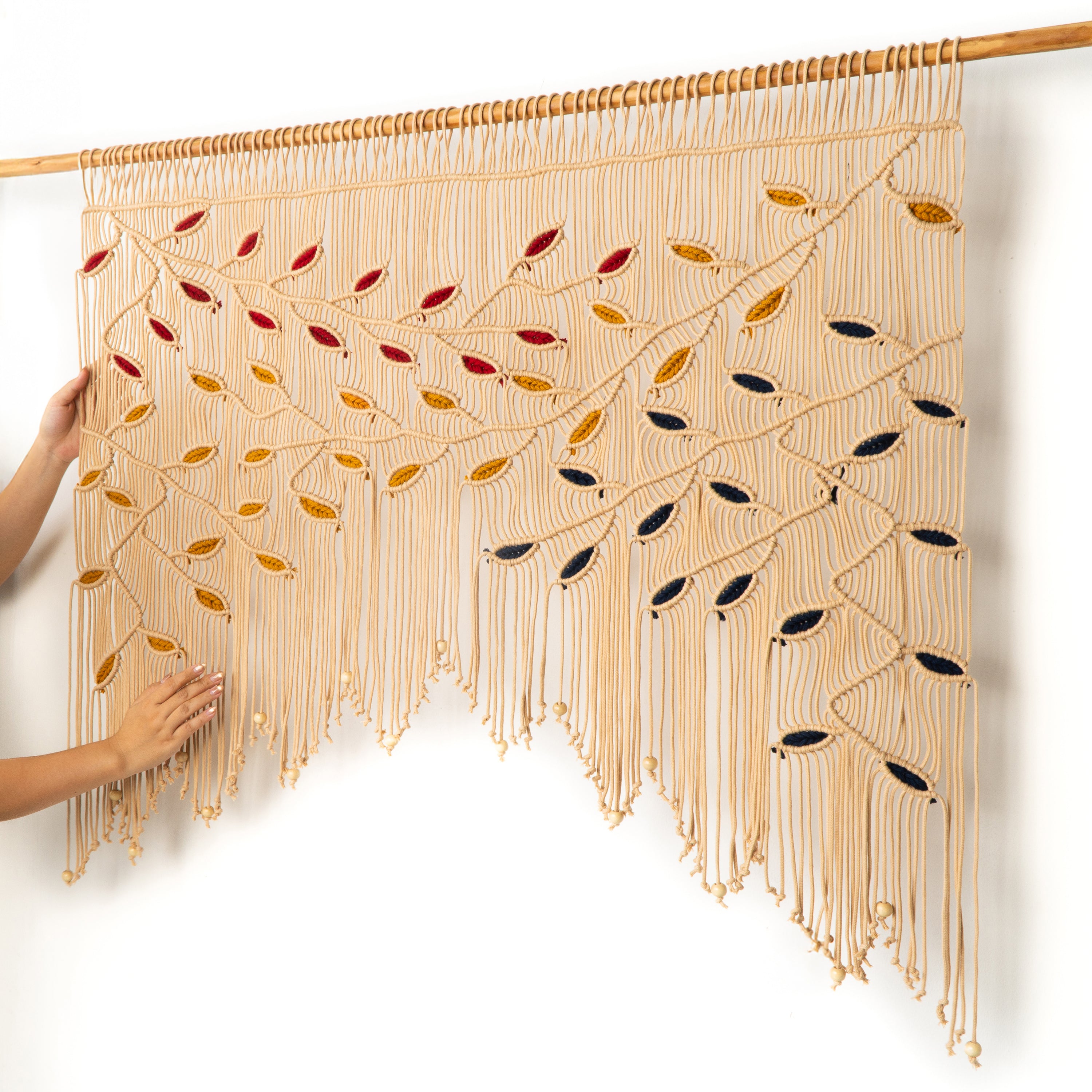 Decorative wall hanging with leaf patterns on a white background