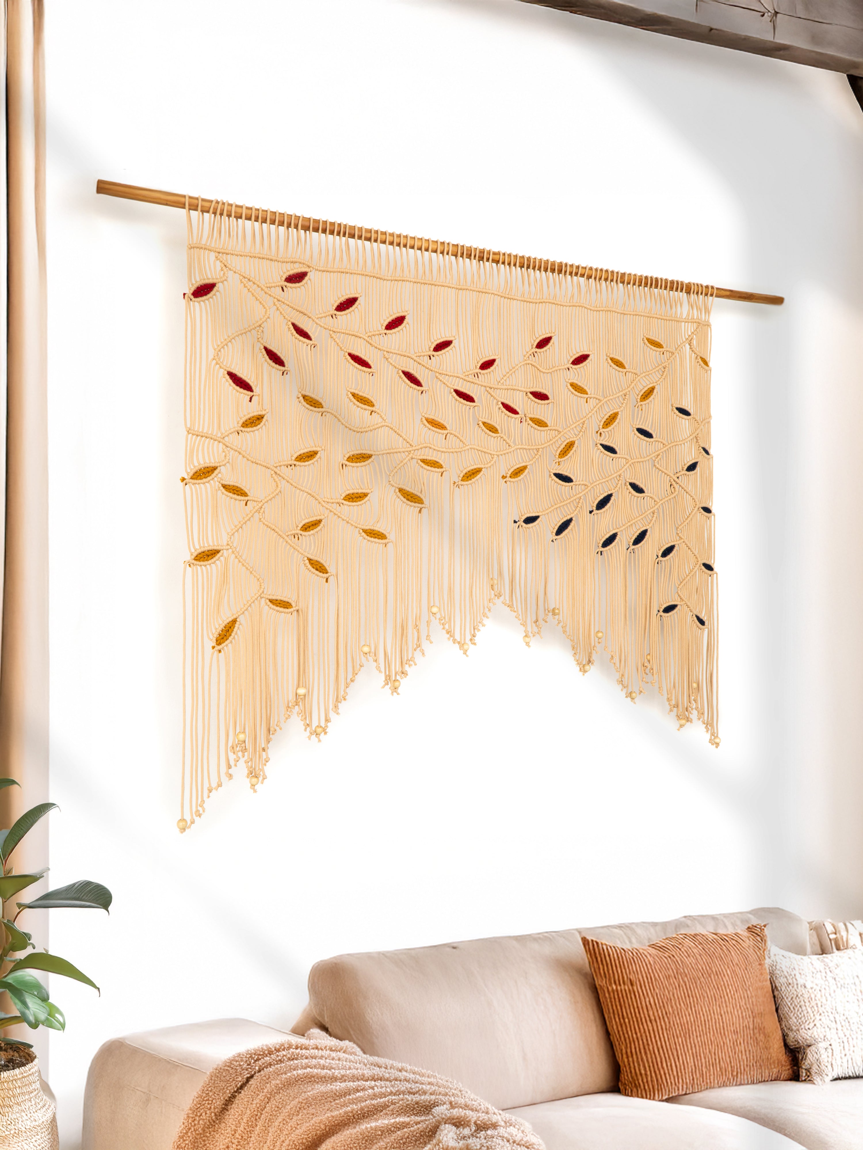 Woven wall art with colorful patterns on a white wall above a sofa.