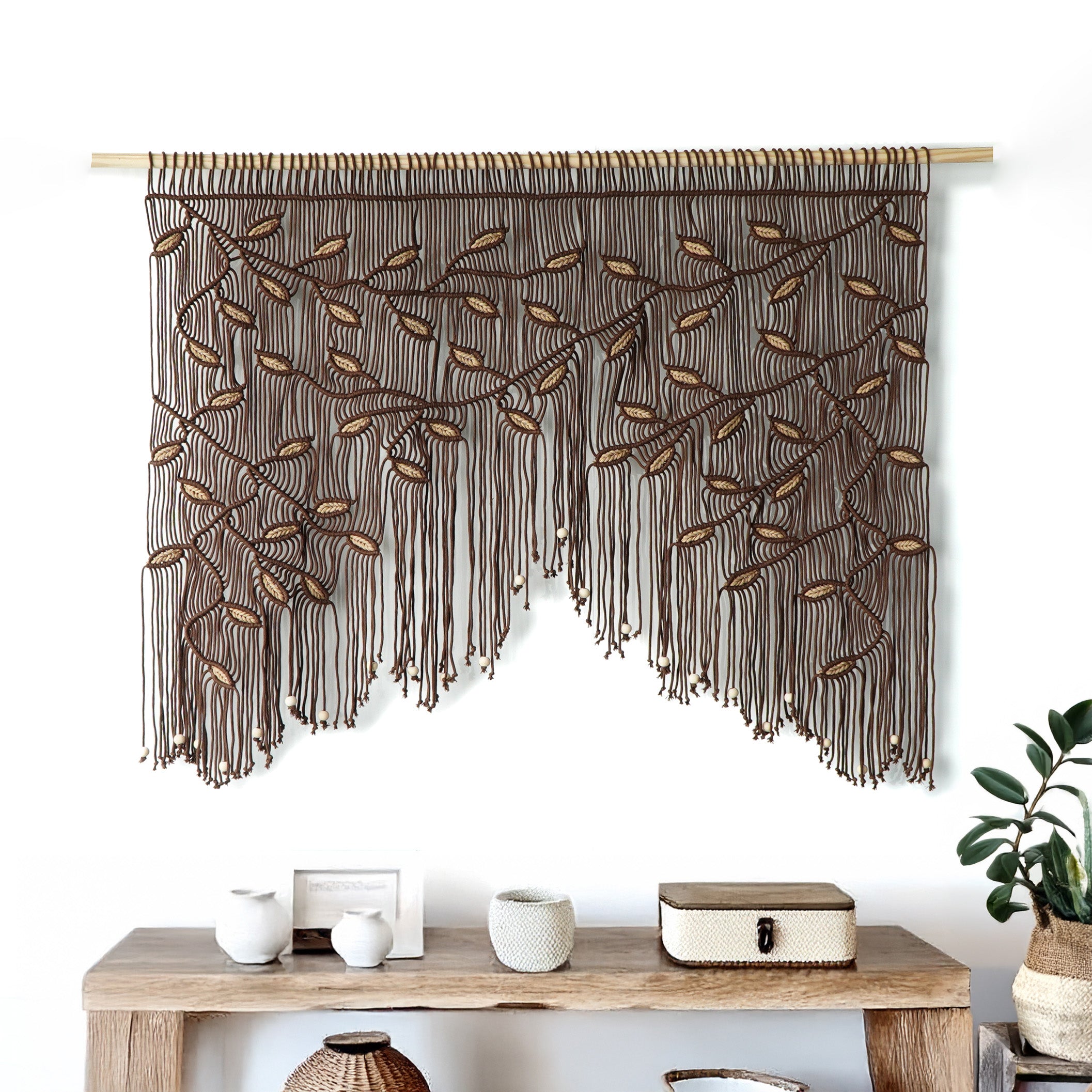 Unique brown macrame valance with a staggered botanical design and 3D textured tan leaves.