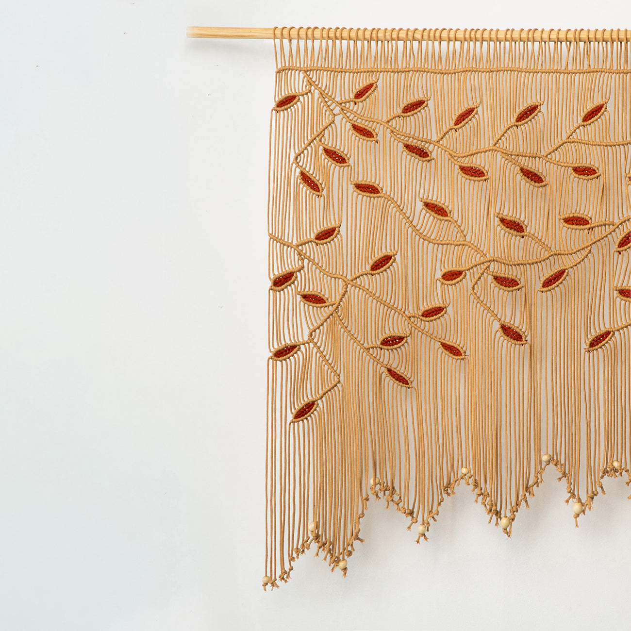 Nature-inspired latte macrame wall decor with terracotta accents, ideal for a cozy nursery focal point.