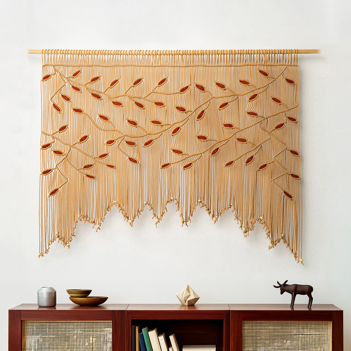 Sun-drenched window topper featuring a hand-knotted latte macrame valance with terracotta vine patterns.