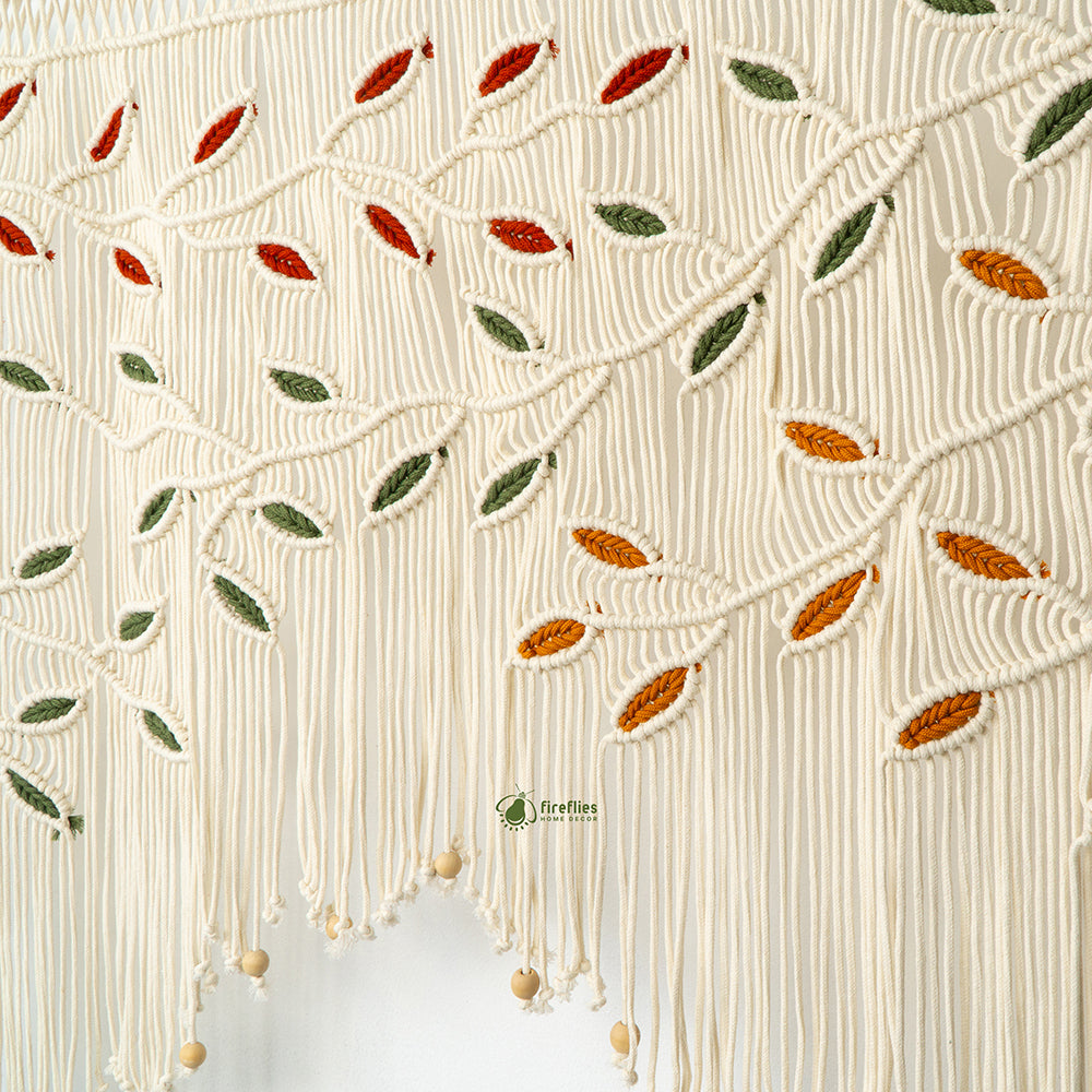 Earthy natural macrame window valance with colorful autumn leaf details and light wood beads.