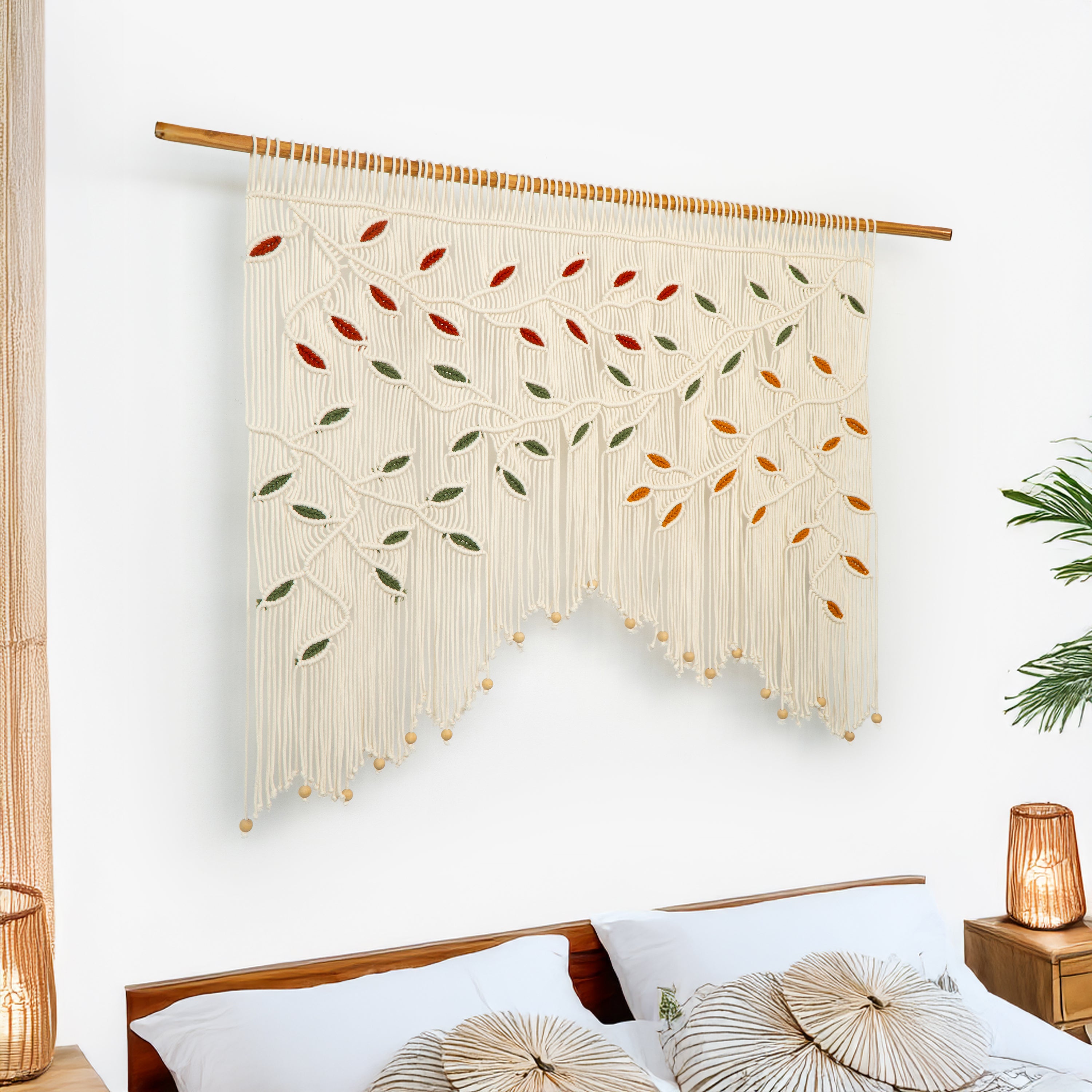 Decorative wall hanging with leaf patterns above a bed in a bedroom setting.