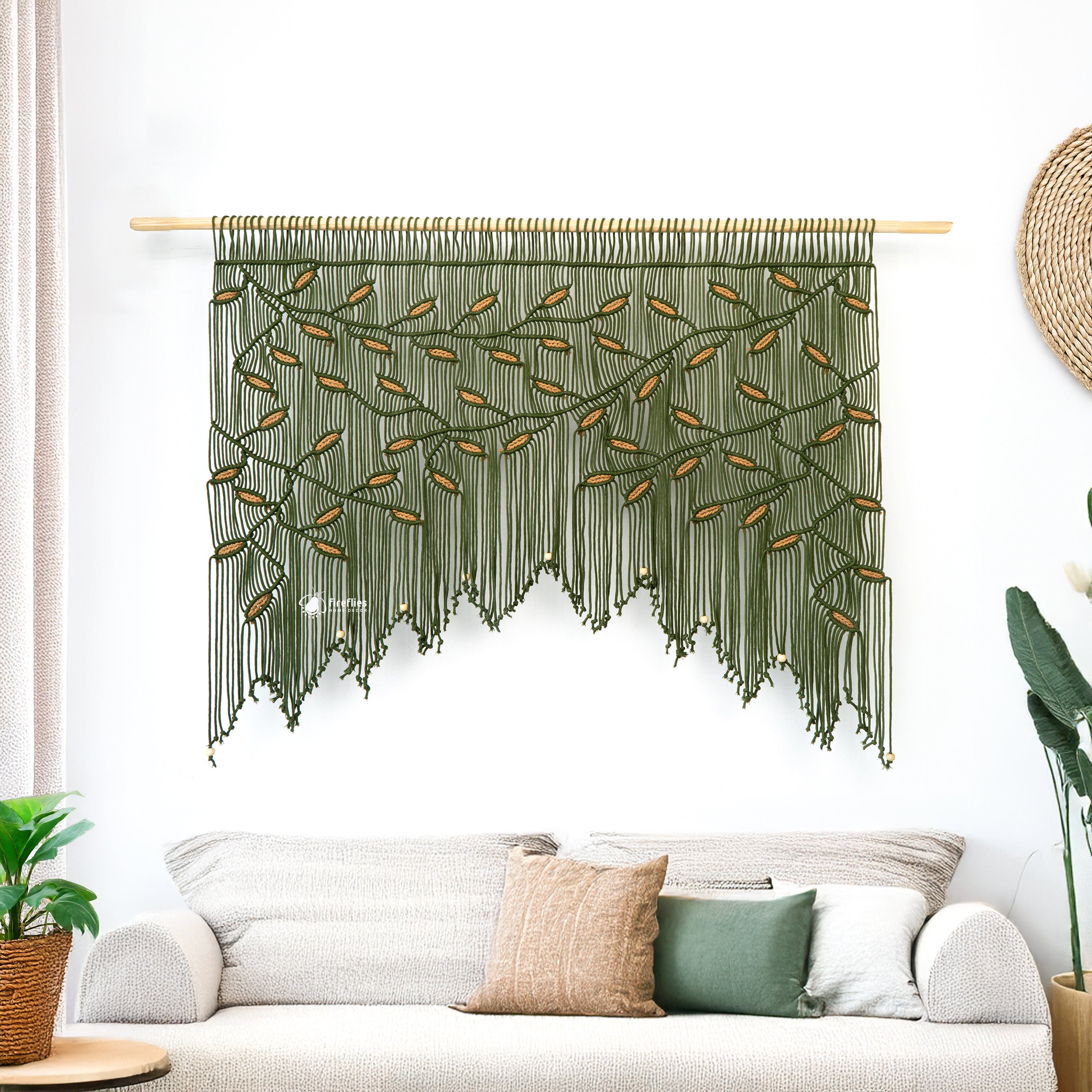 Macrame wall hanging above a bed with decorative pillows and a framed picture.