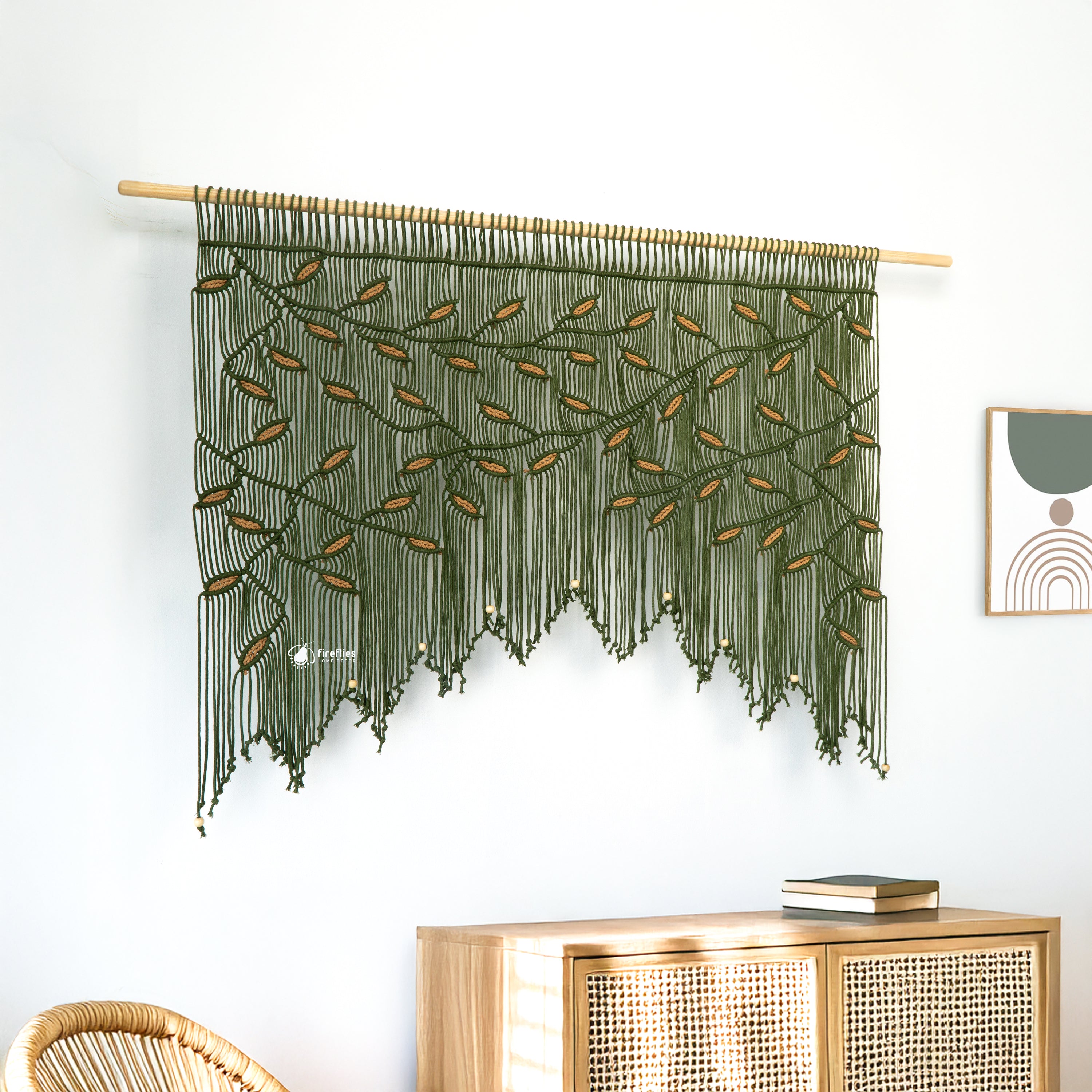 Three macrame wall hangings on a white wall with a plant and sofa in the foreground.