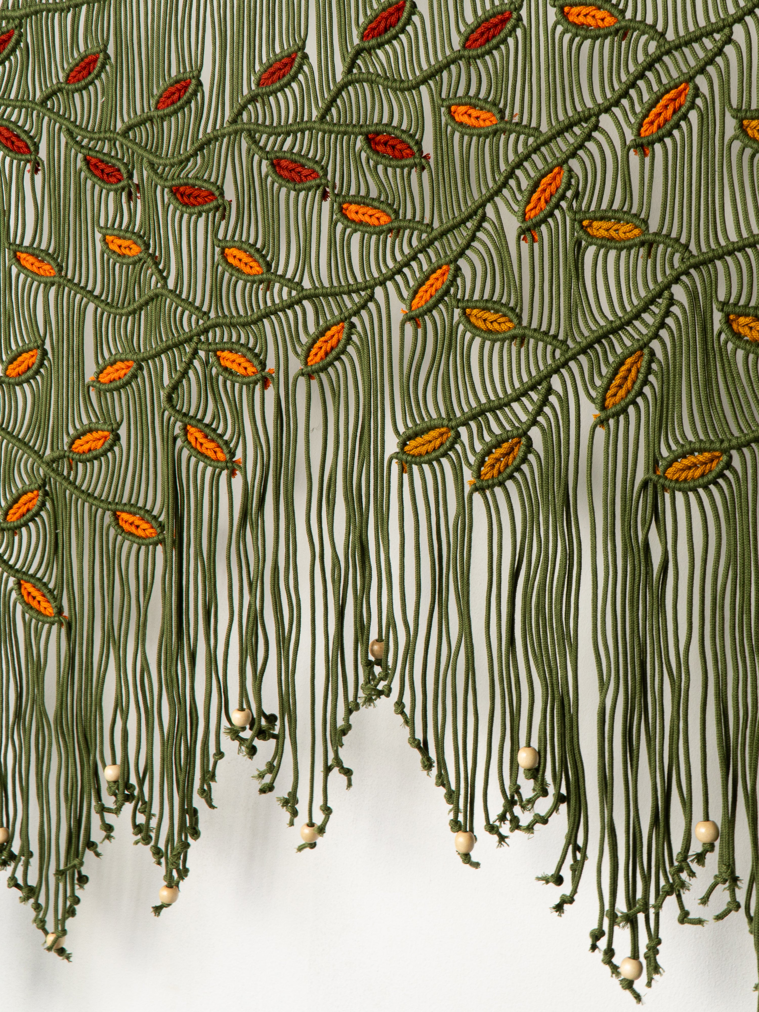 Textile with green and orange pattern on a white background