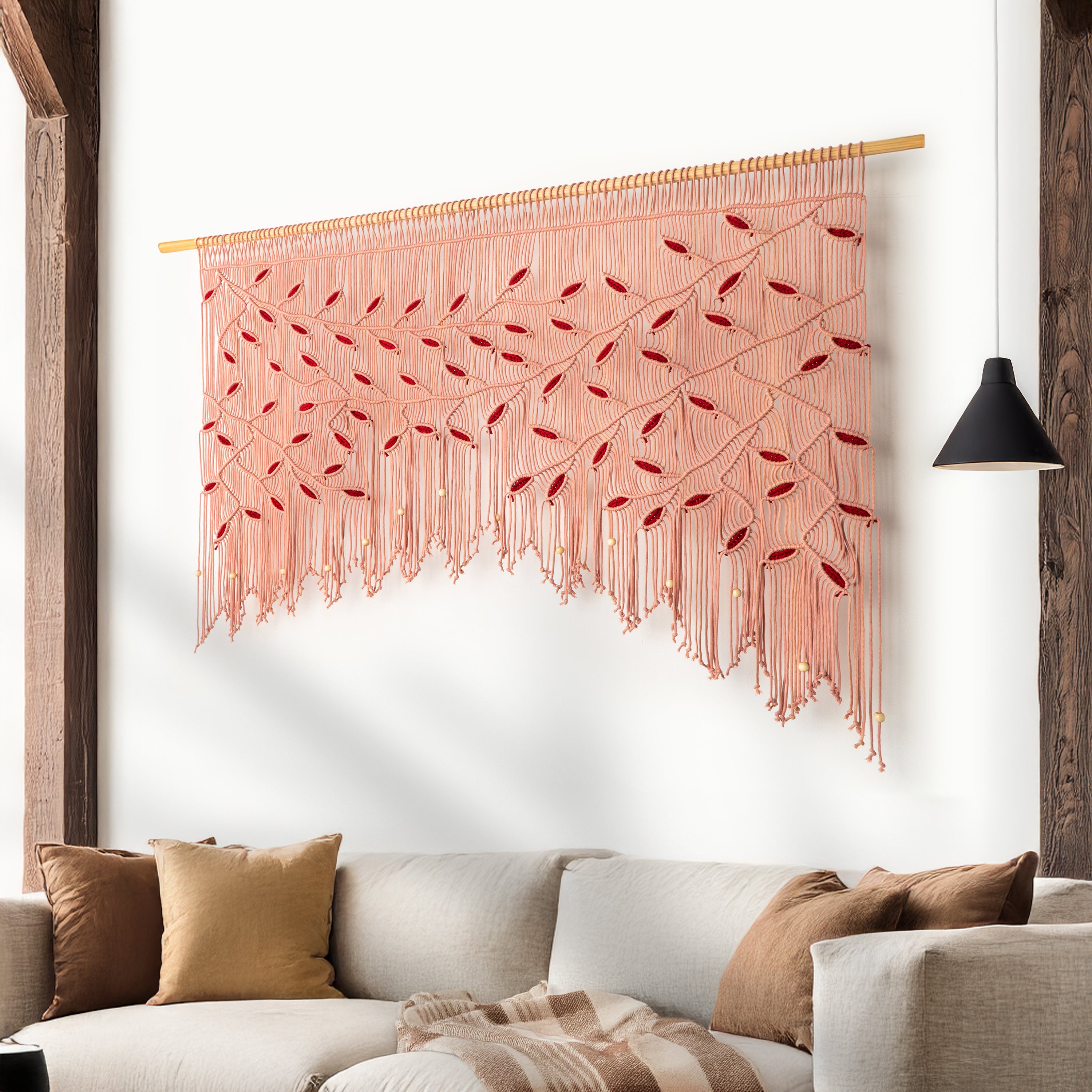 Decorative wall hanging with pink and red pattern above a sofa with pillows.
