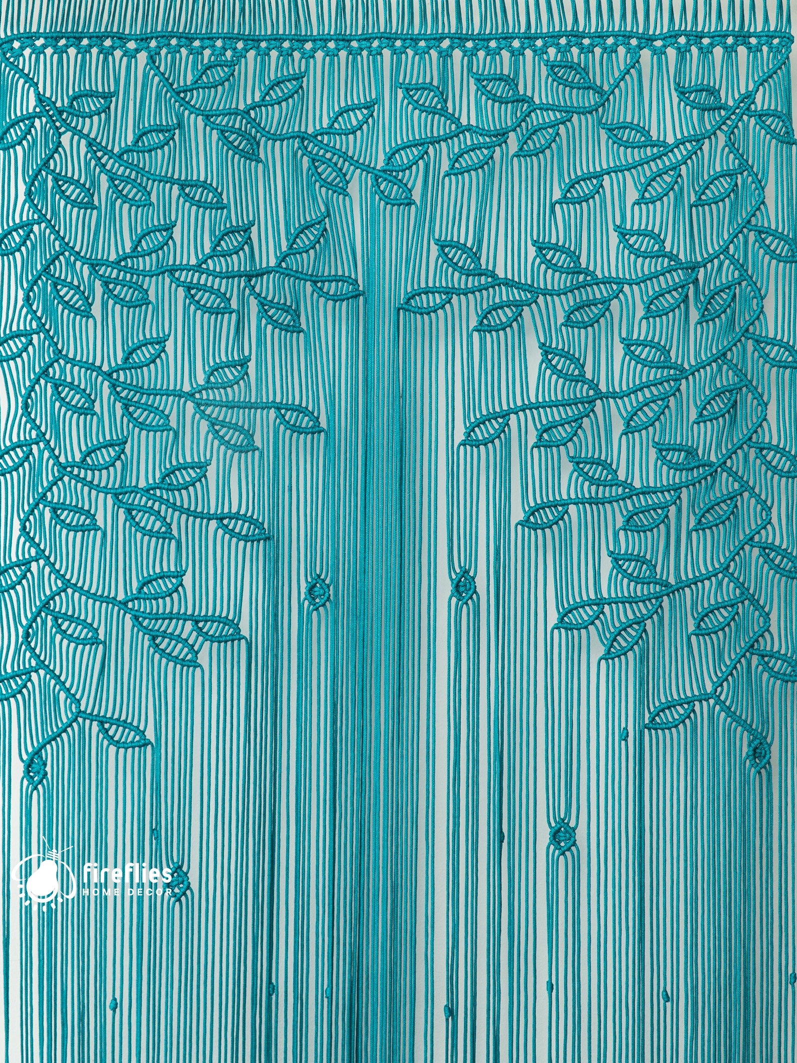 Teal curtain with leaf pattern, brand 'Firies' visible