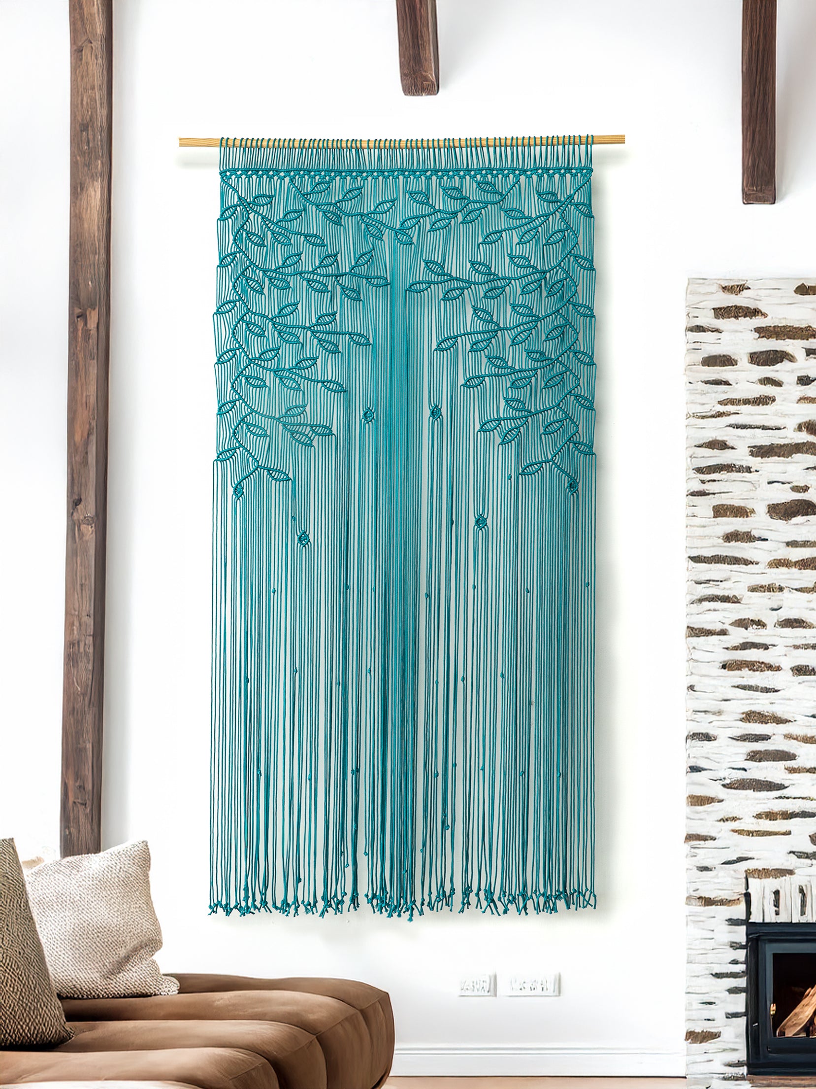 Teal string art hanging on a white wall with wooden beams and a textured wall.