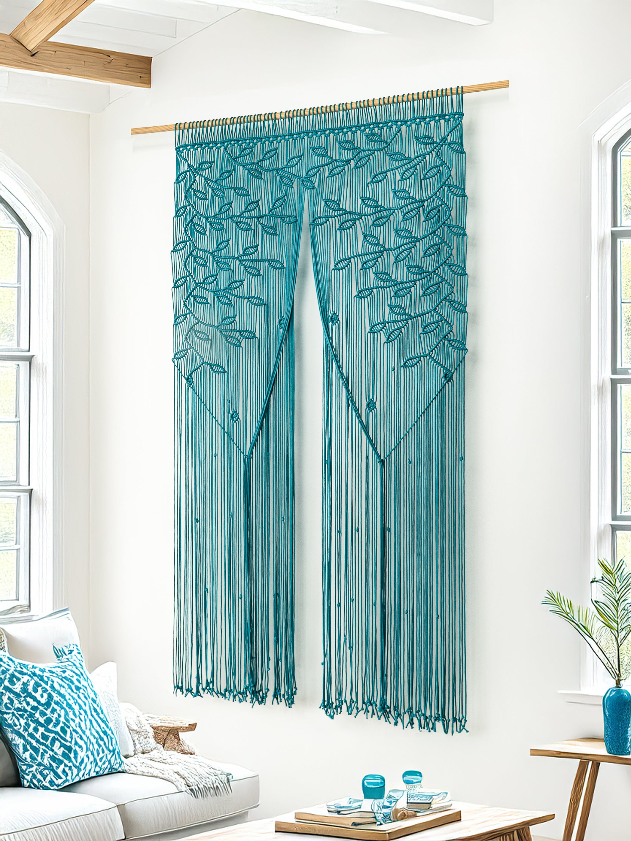 Teal string curtain hanging in a room with white walls and a couch.