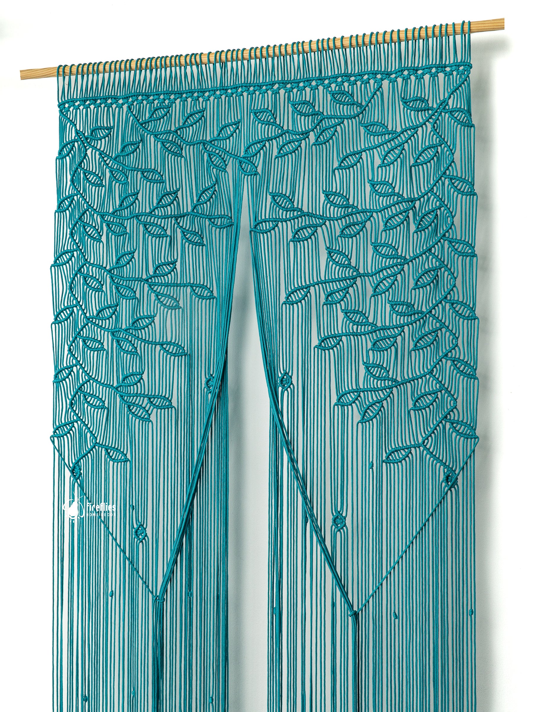 Teal string curtain with leaf pattern on a white background