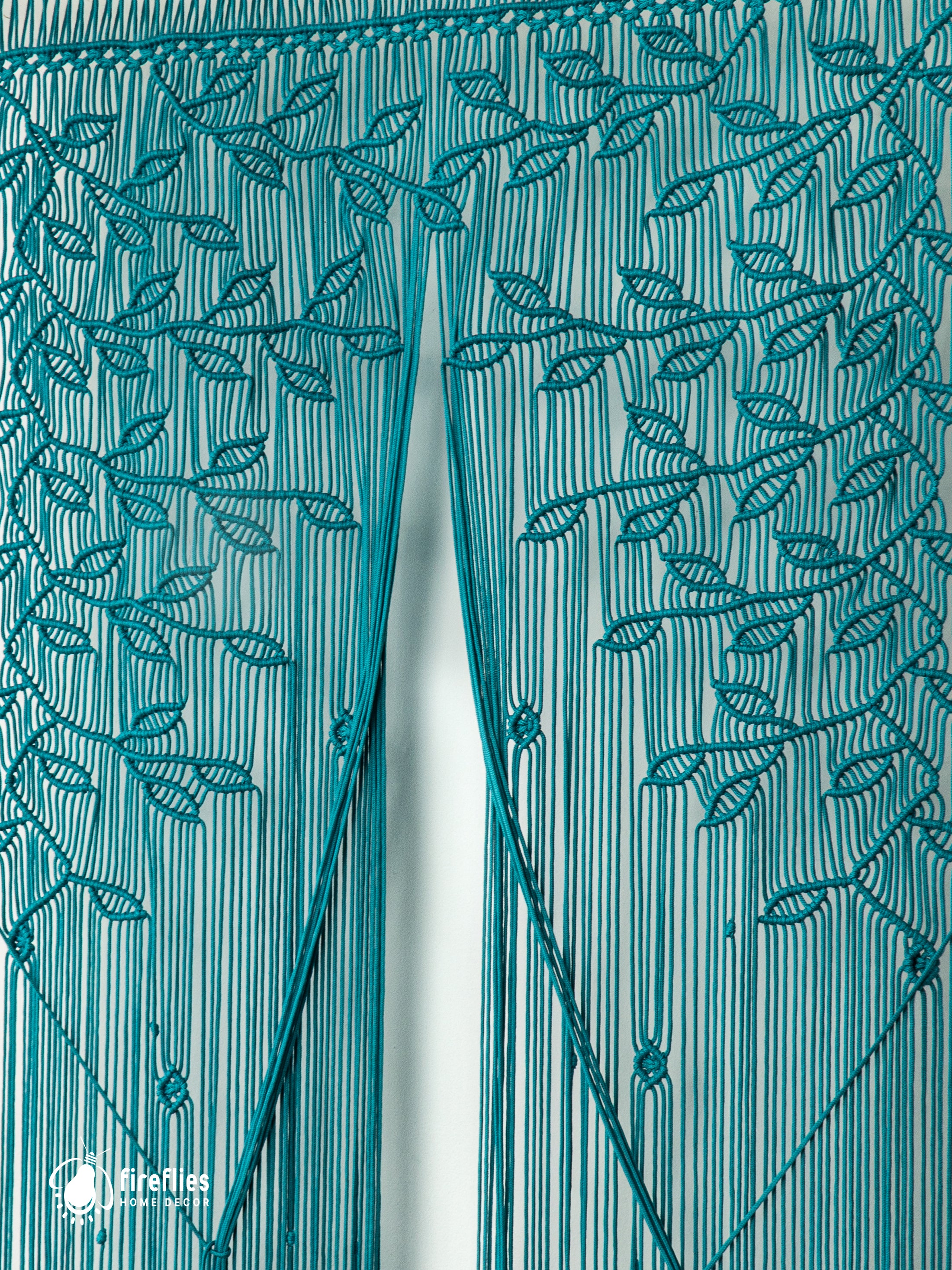 Teal string curtain with leaf pattern on a white background