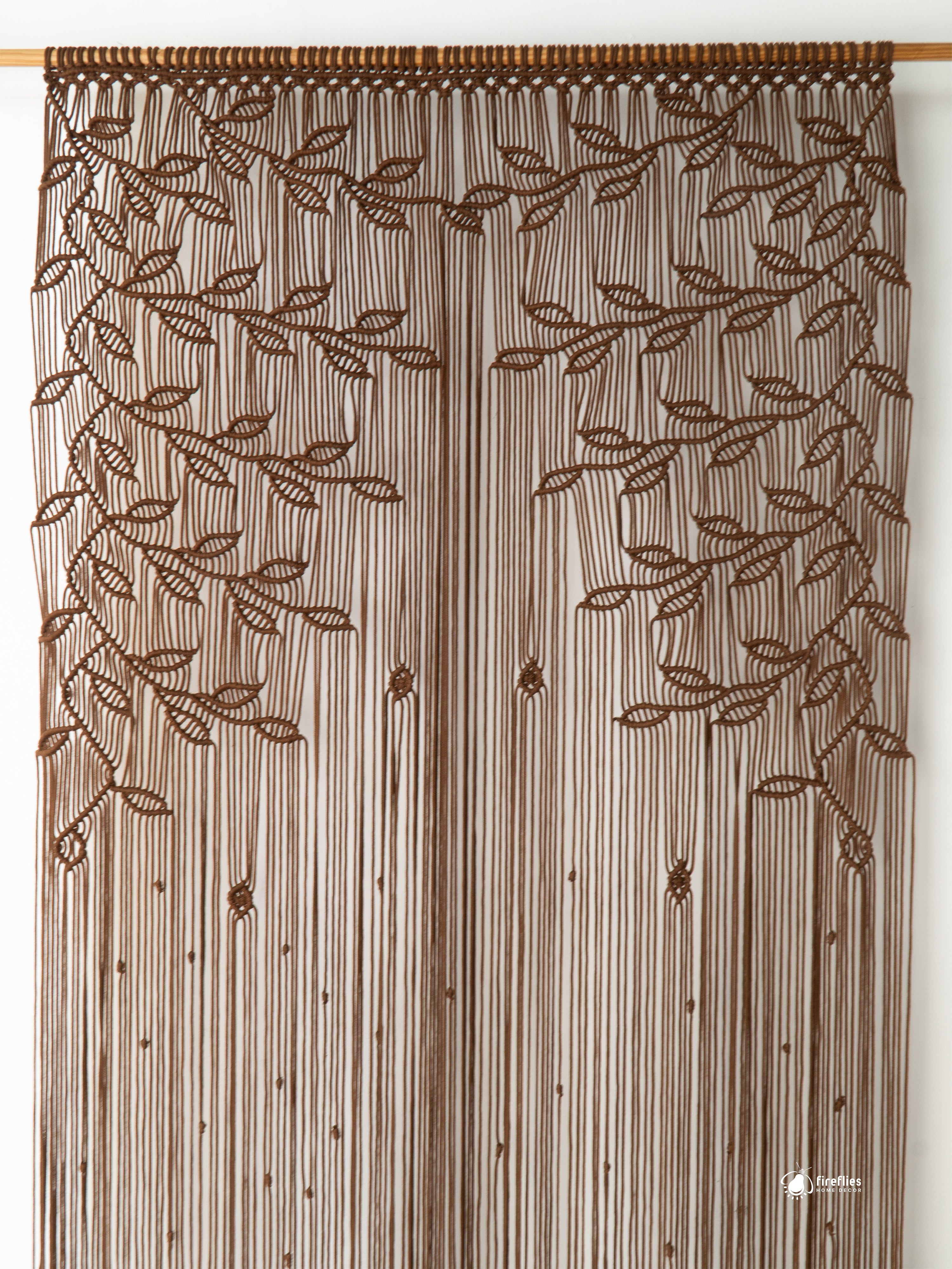Brown beaded curtain with leaf pattern on a white background