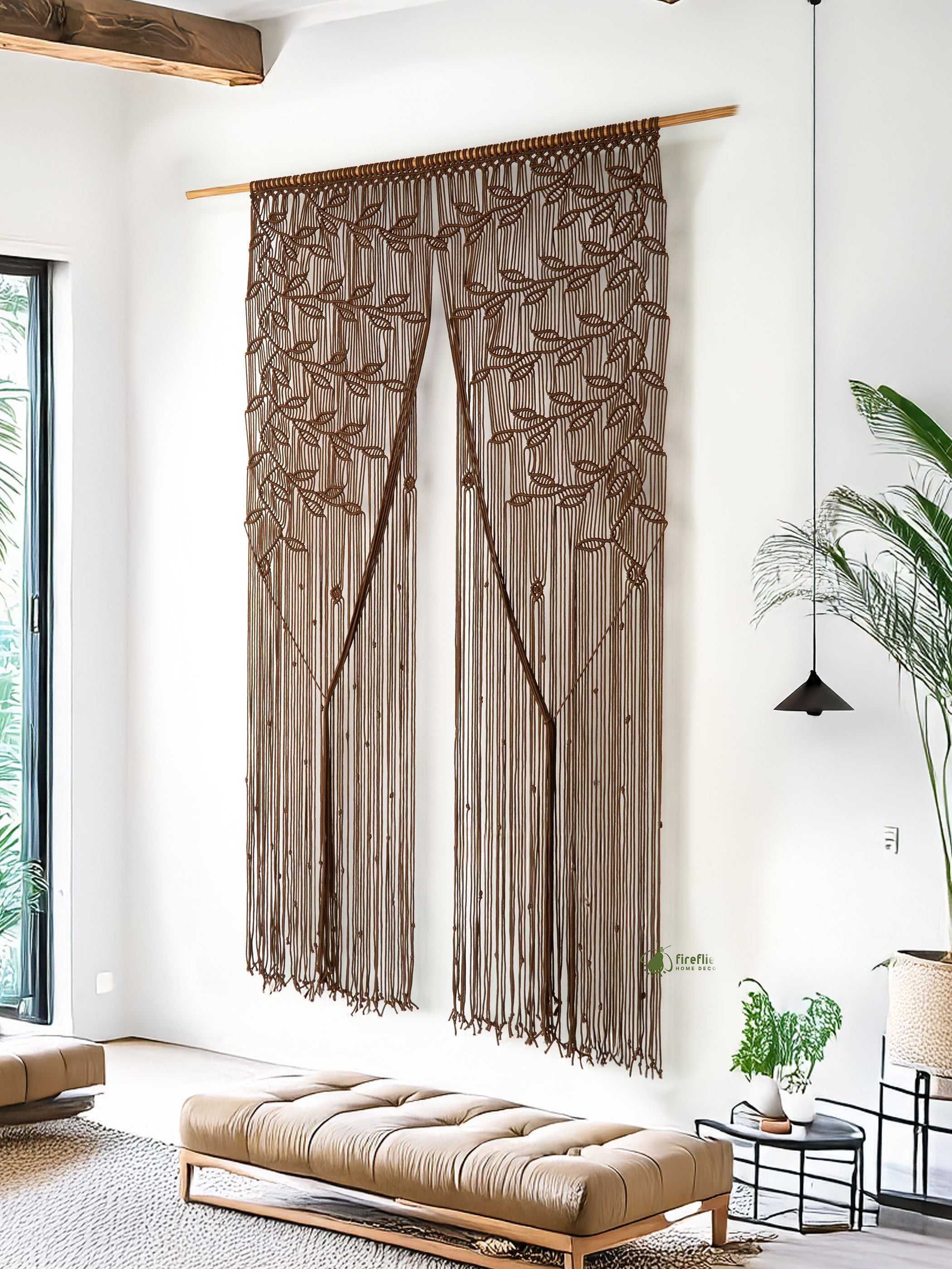 Decorative brown curtain with leaf patterns hanging in a modern living room.