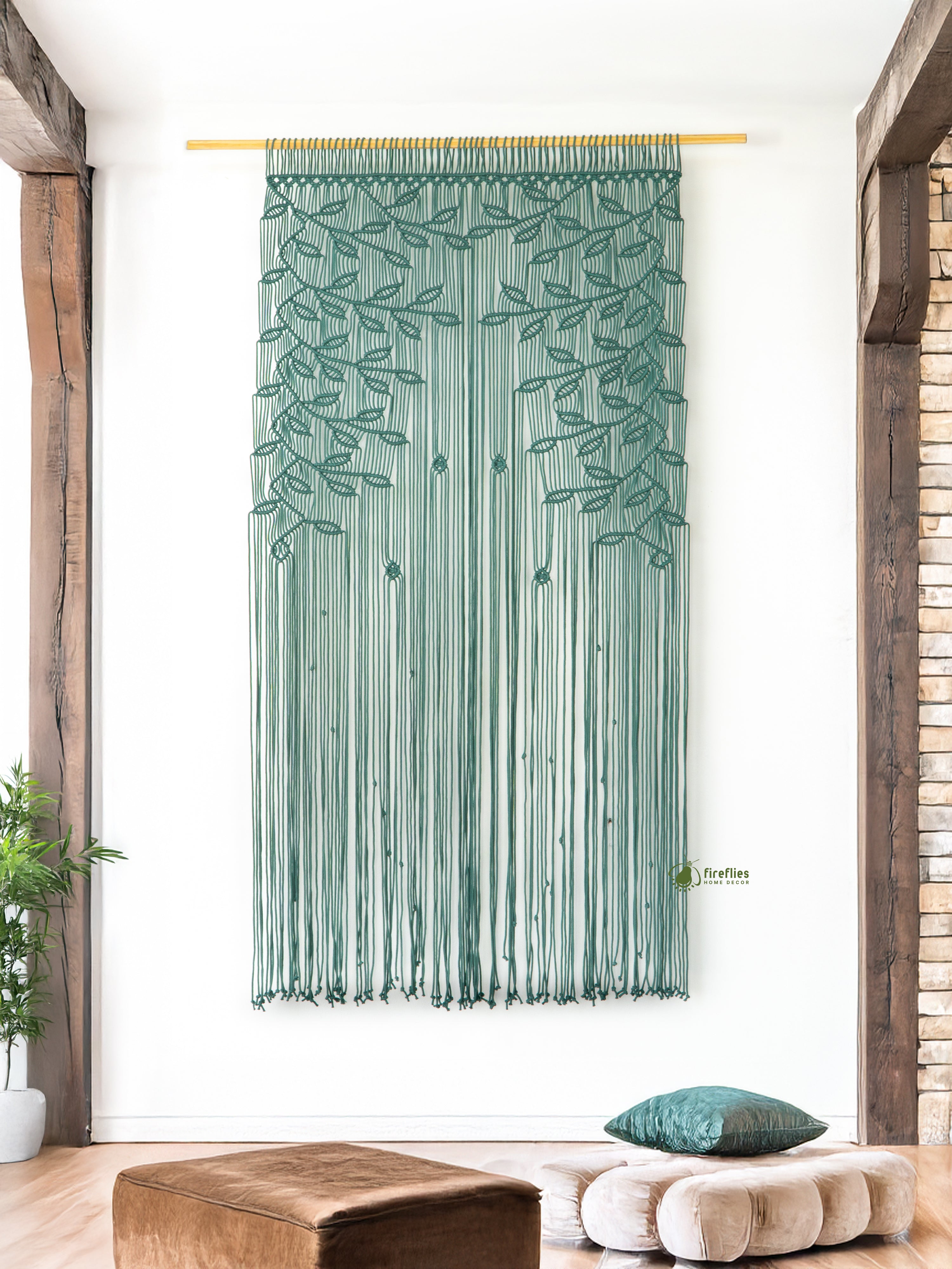 Decorative string curtain with leaf pattern in a room with wooden beams and plants.