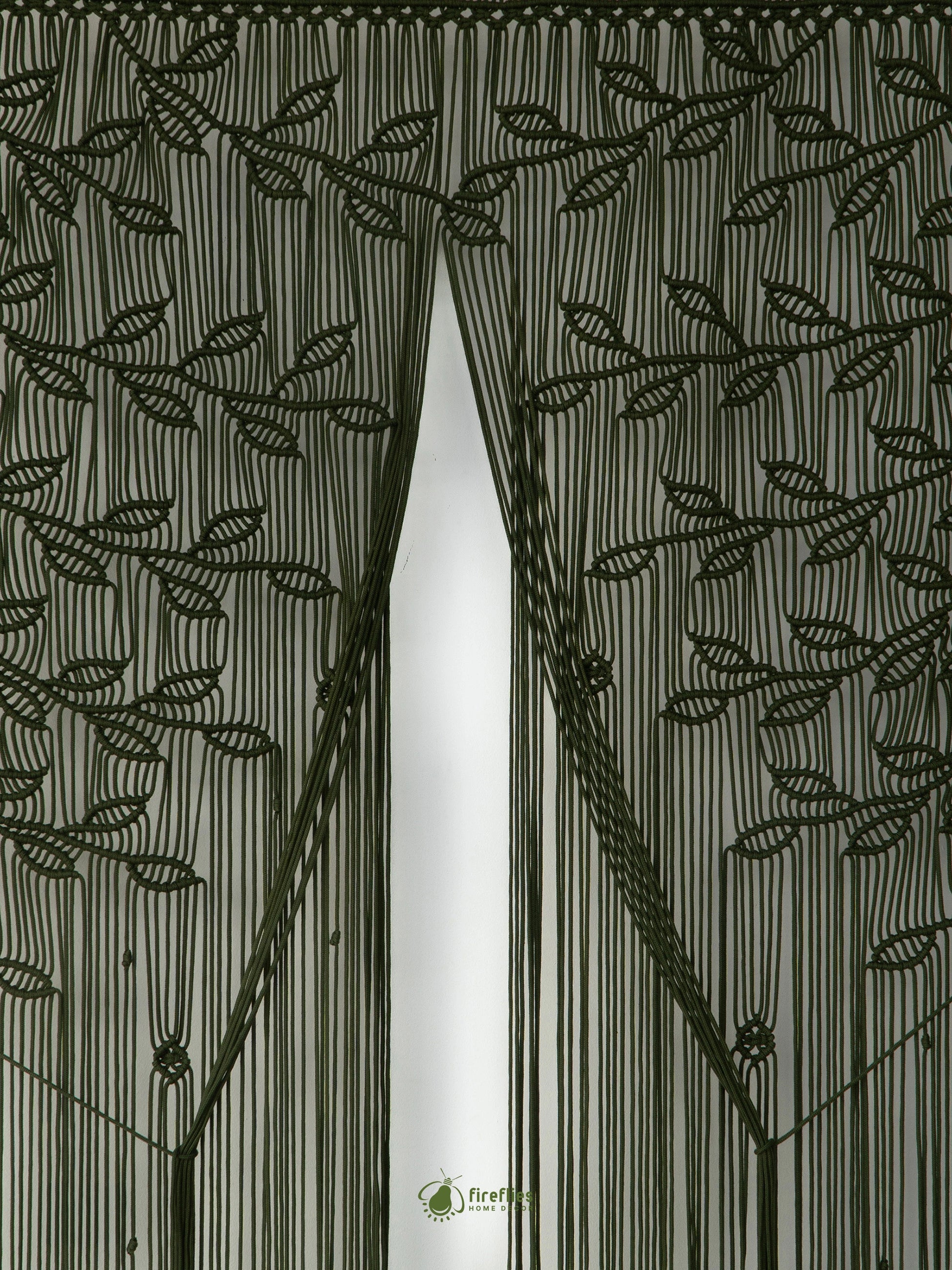 A dark olive green sheer curtain panel with an embroidered leaf and vine pattern, hanging in front of a window and shown with a matching tie-back cord.