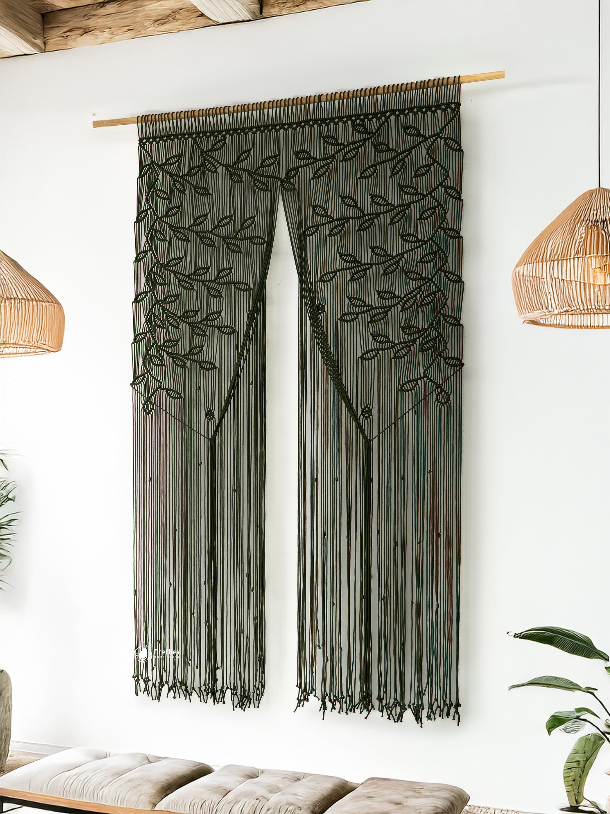Decorative wall hanging with leaf patterns on a white wall.