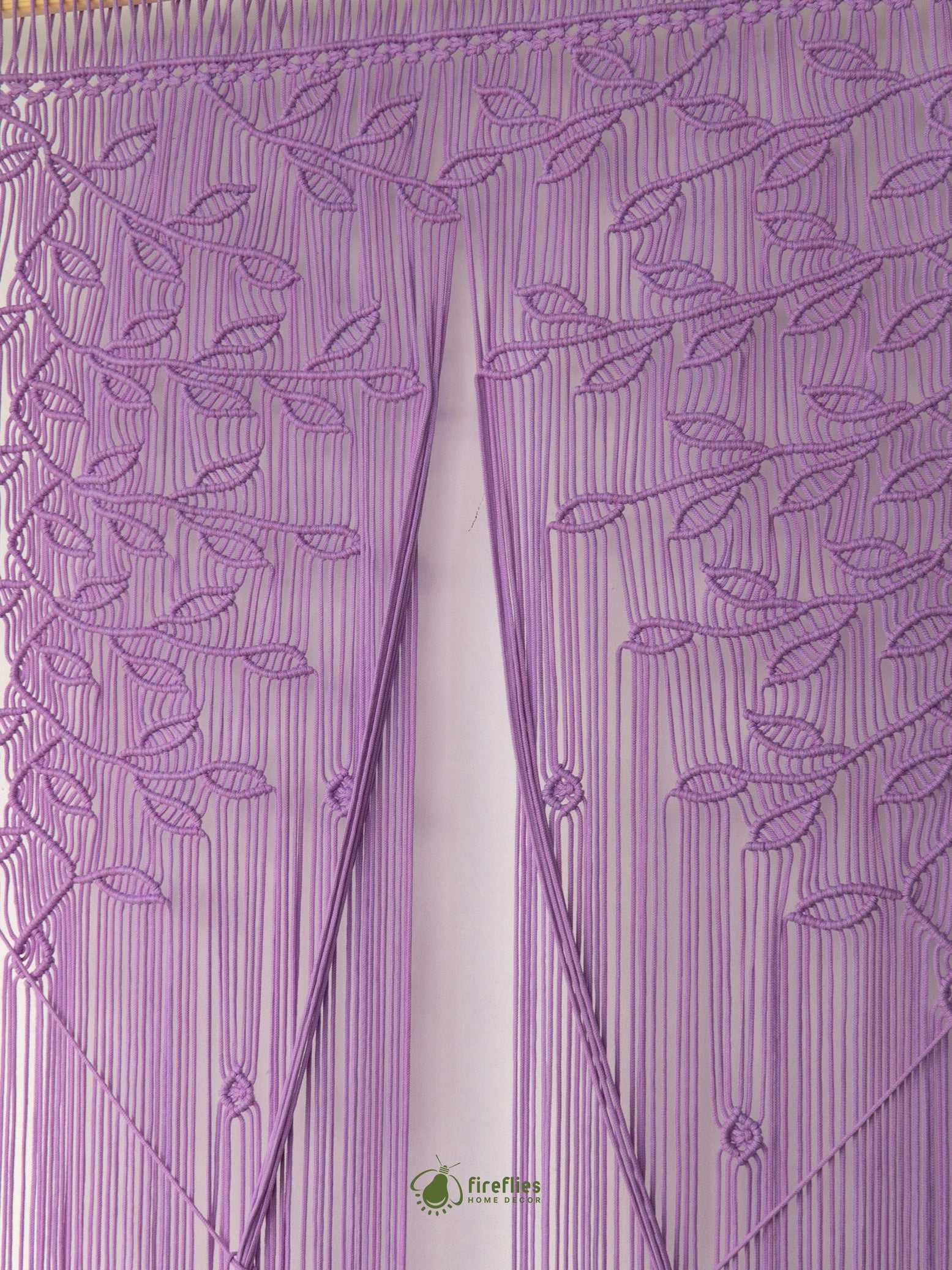 A purple embroidered bunting curtain with leaf and vine patterns and hanging fringe, shown hanging against a white background.