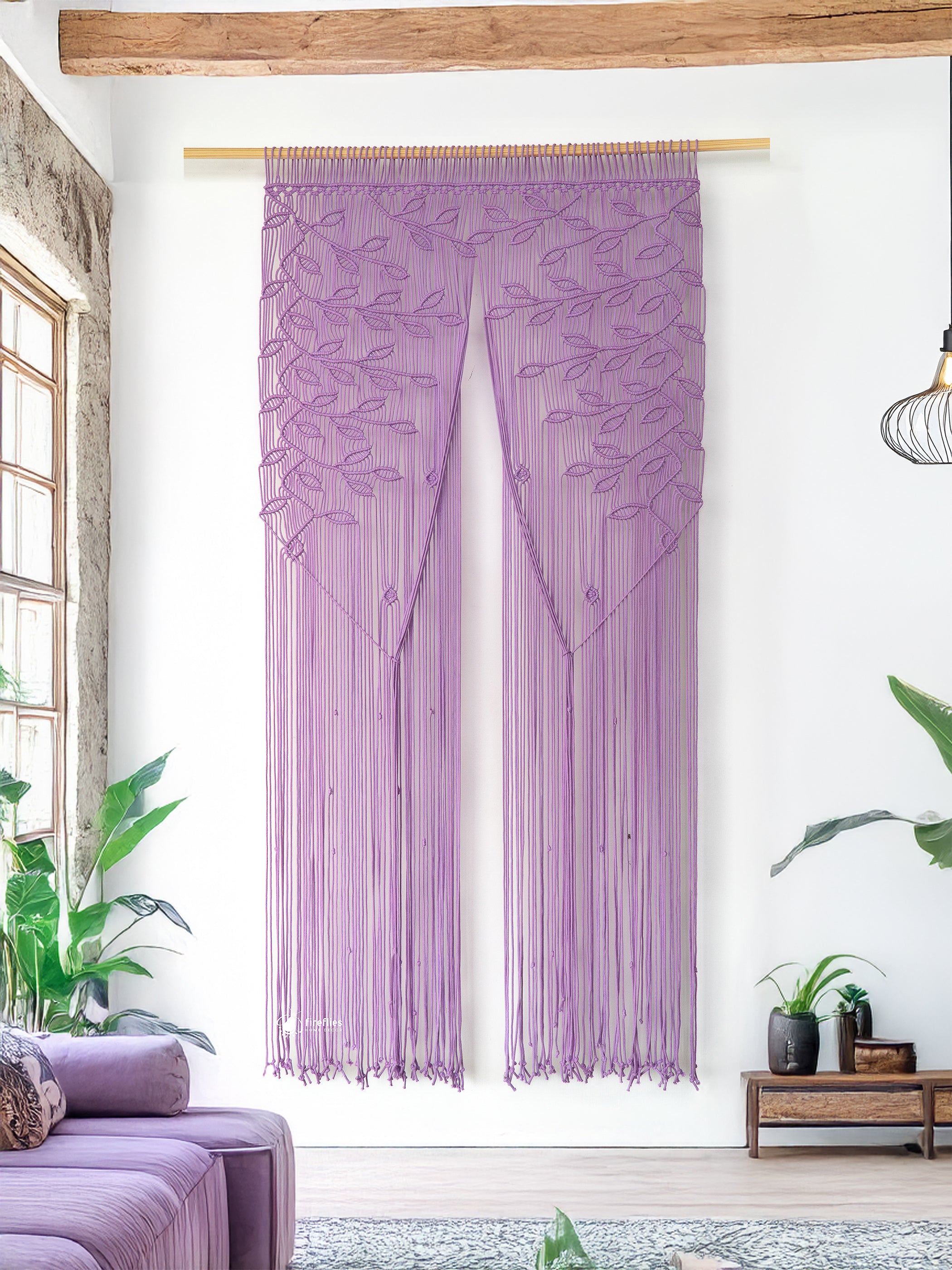 Decorative curtain with leaf pattern in a room with plants and furniture.