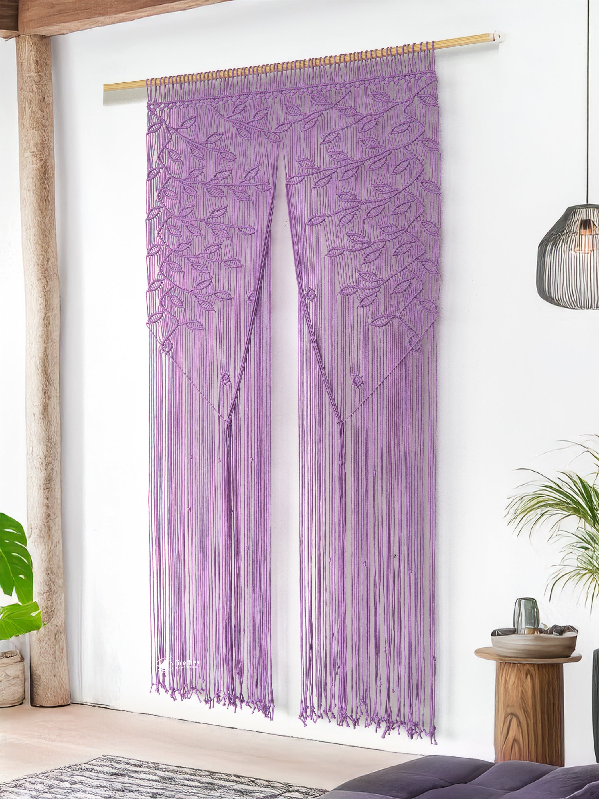 Decorative wall hanging with leaf patterns on a white wall.