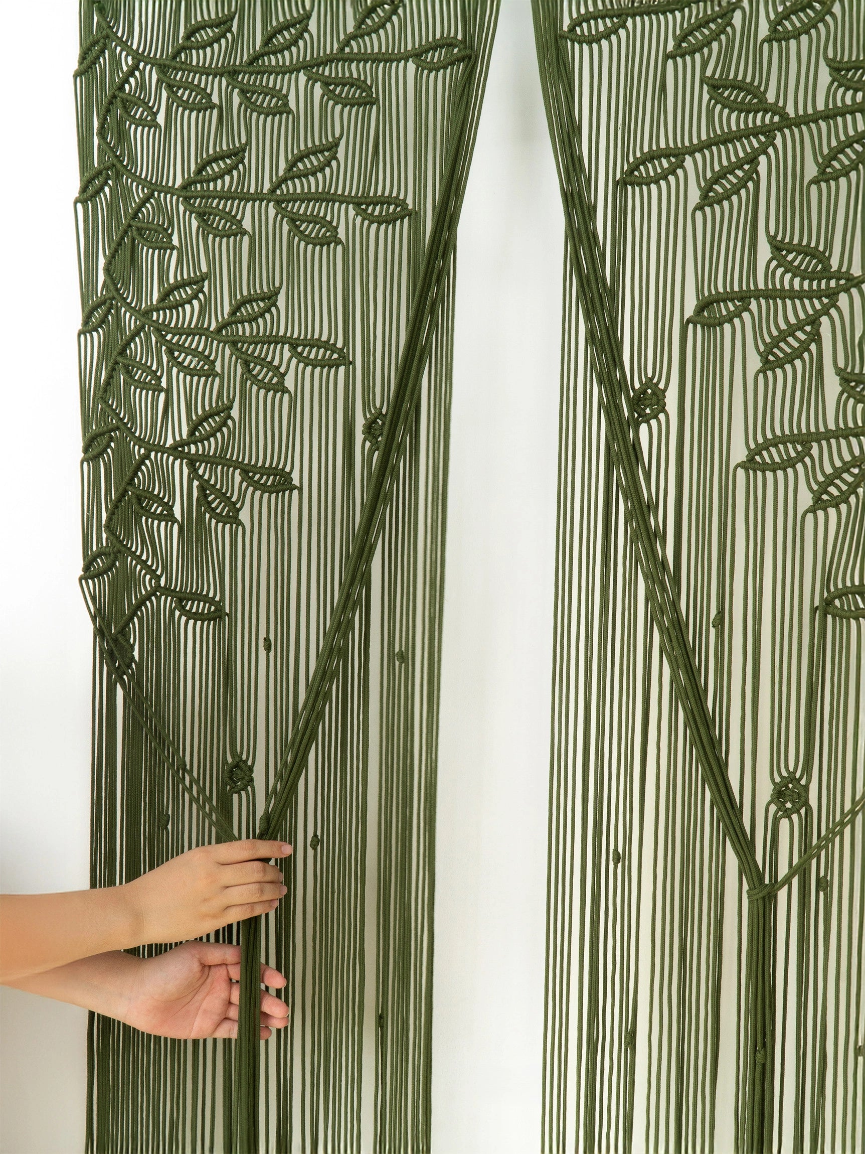 Detailed botanical leaf canopy knotwork on an earthy olive green cotton macrame wall hanging panel.