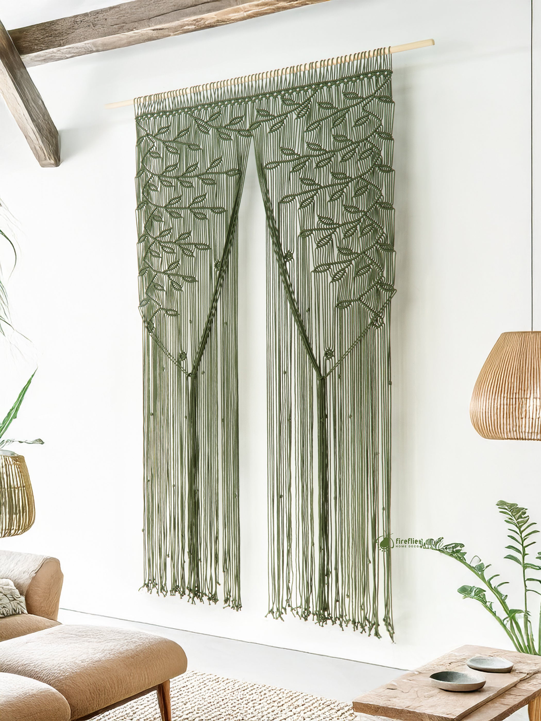 Decorative string curtain with leaf pattern hanging in a room with windows and plants.