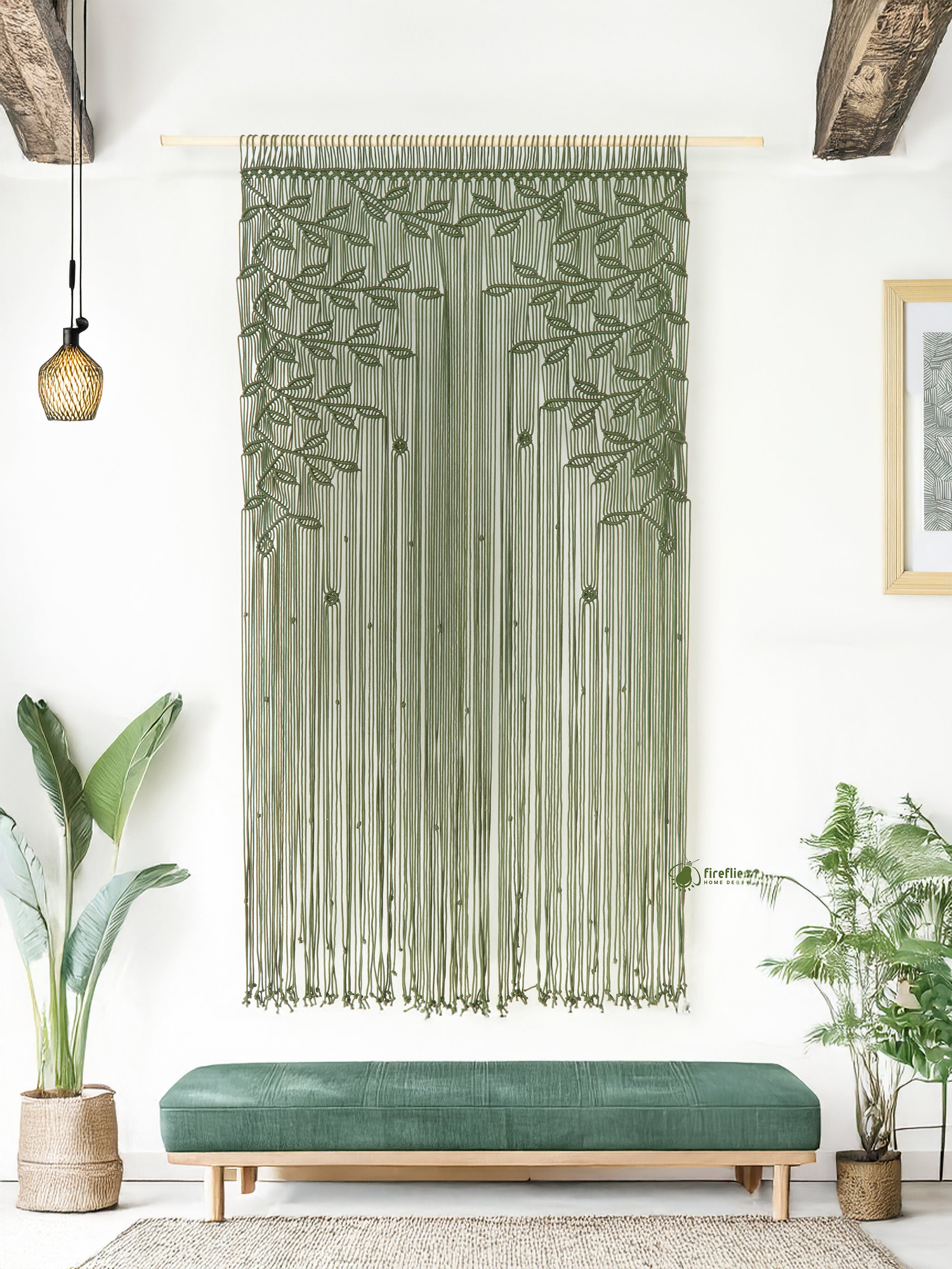 Decorative wall hanging with leaf pattern in a room with plants and a bench.