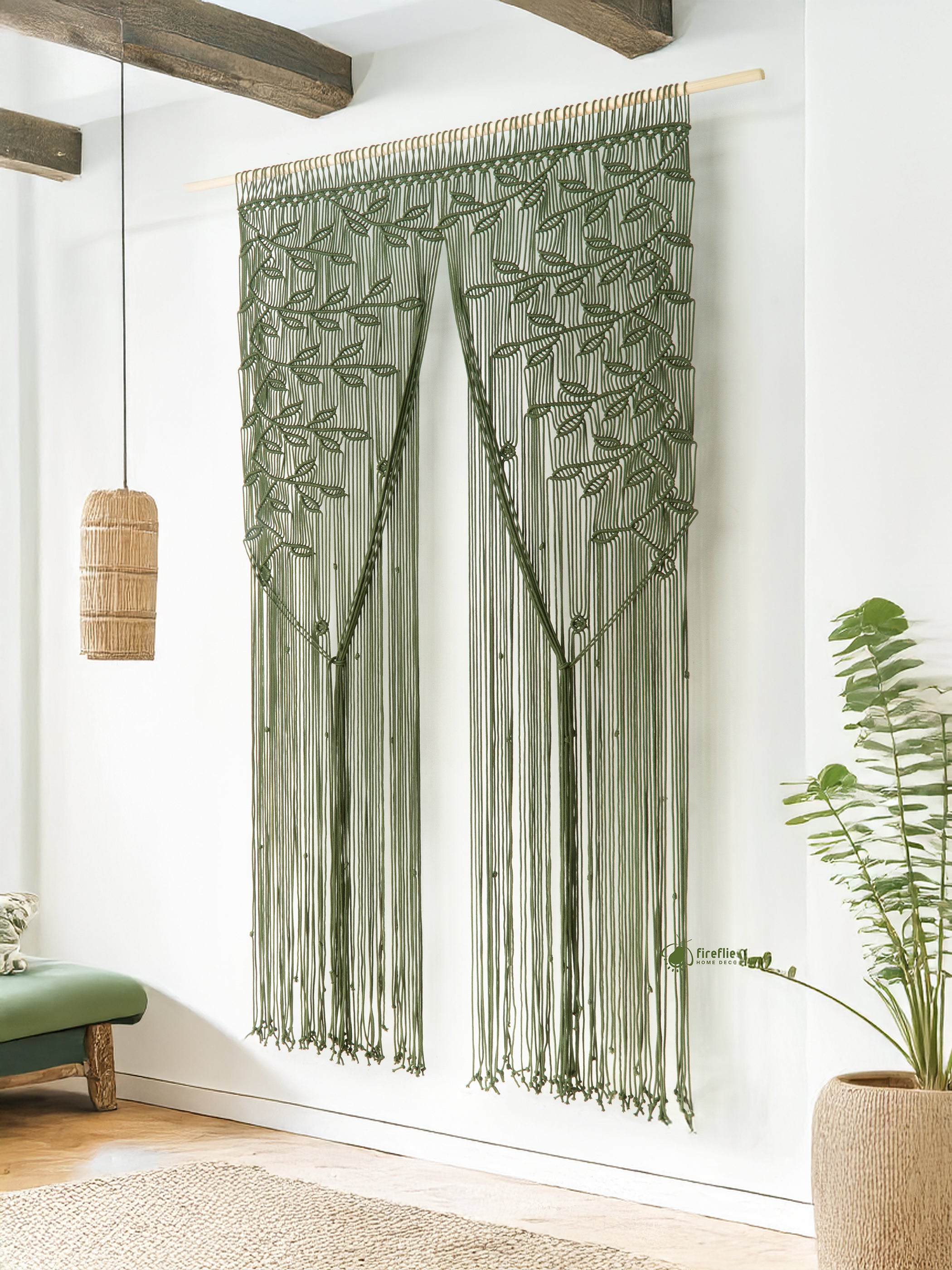 Decorative string curtain with leaf pattern hanging on a white wall.