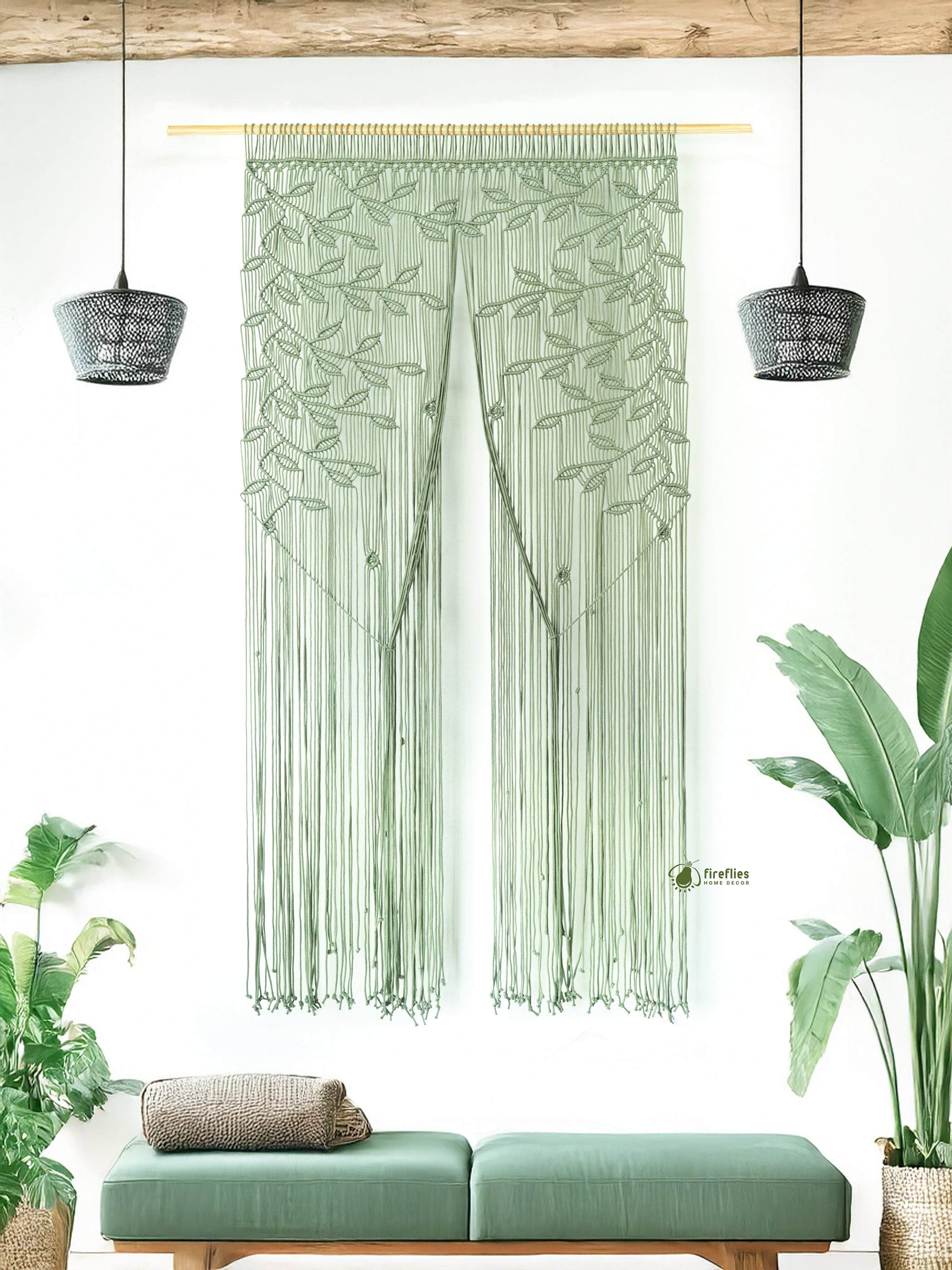 Green woven curtain with leaf pattern in a room with plants and a bench.
