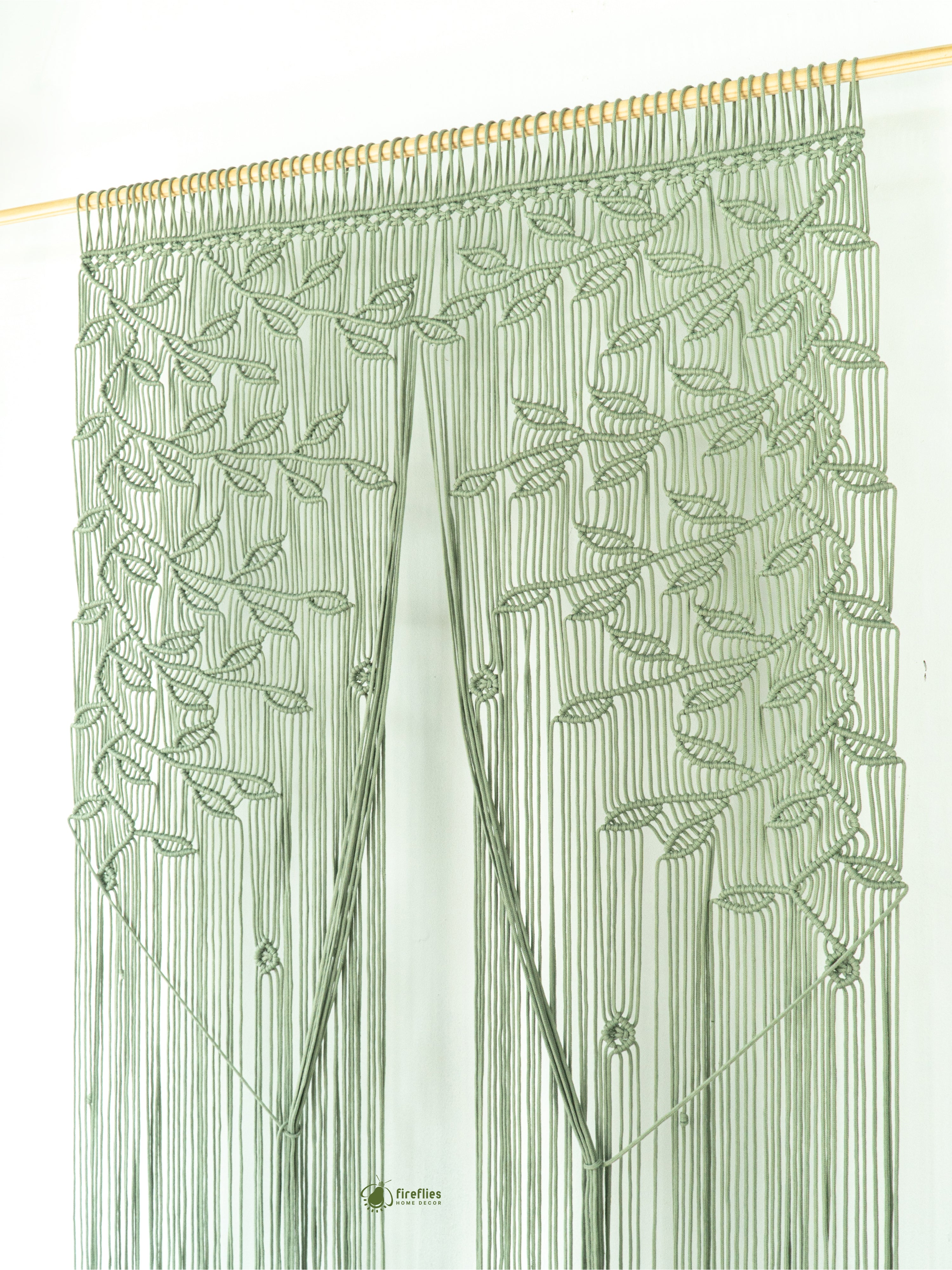 Green string curtain with leaf pattern on a white background