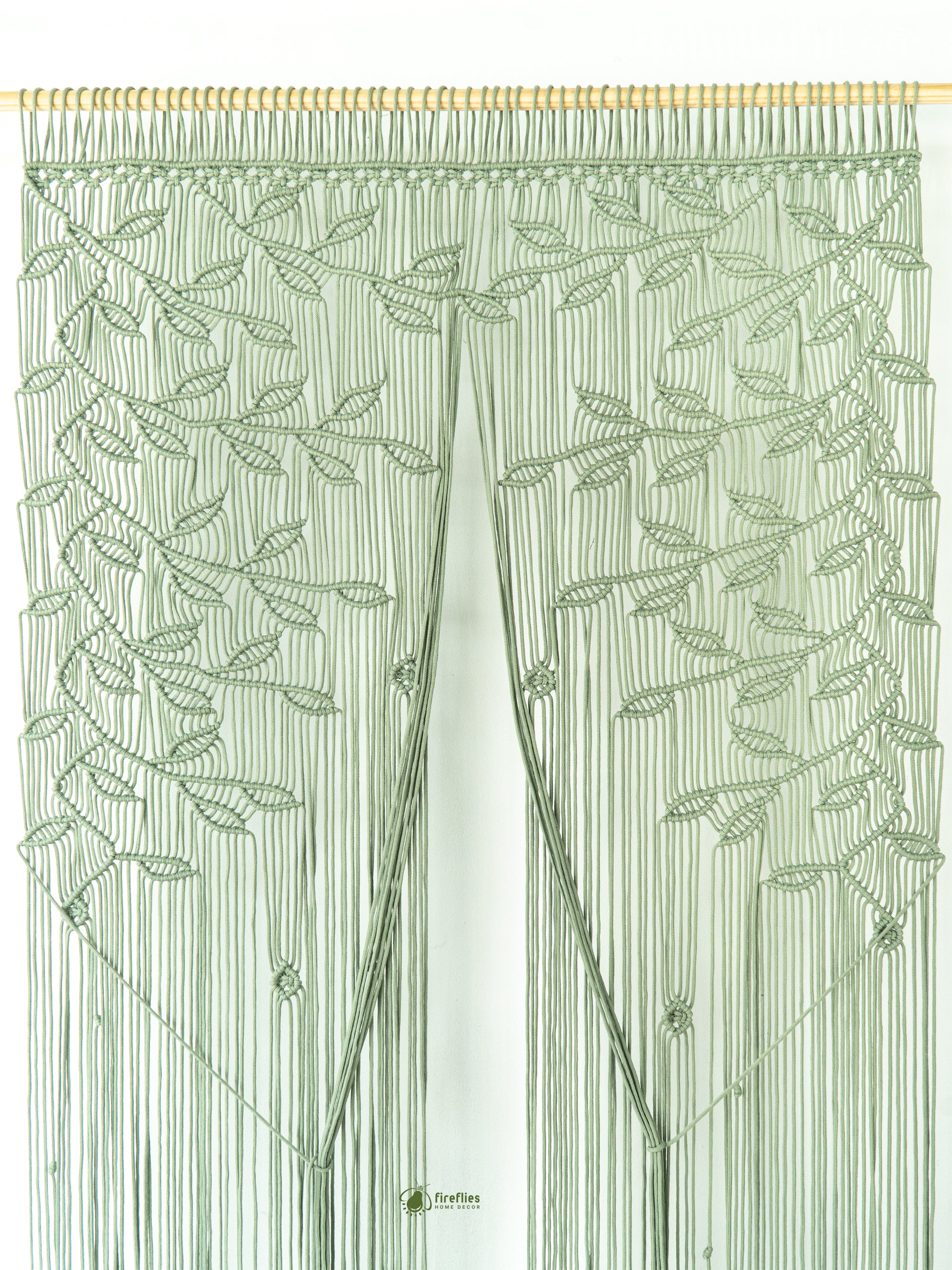 Decorative green curtain with leaf pattern on a white background