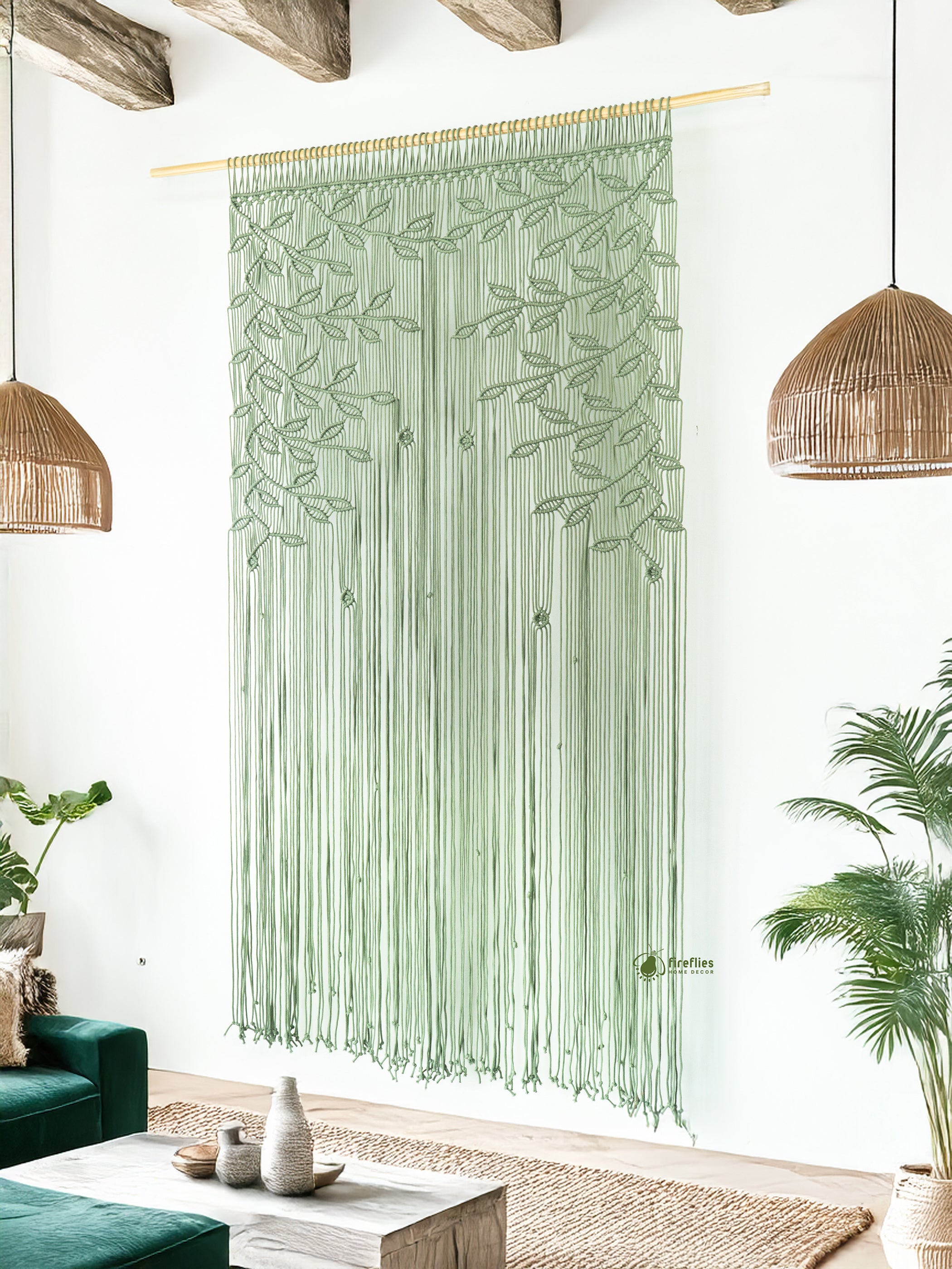 Green macramé curtain hanging in a living room with plants and a coffee table.