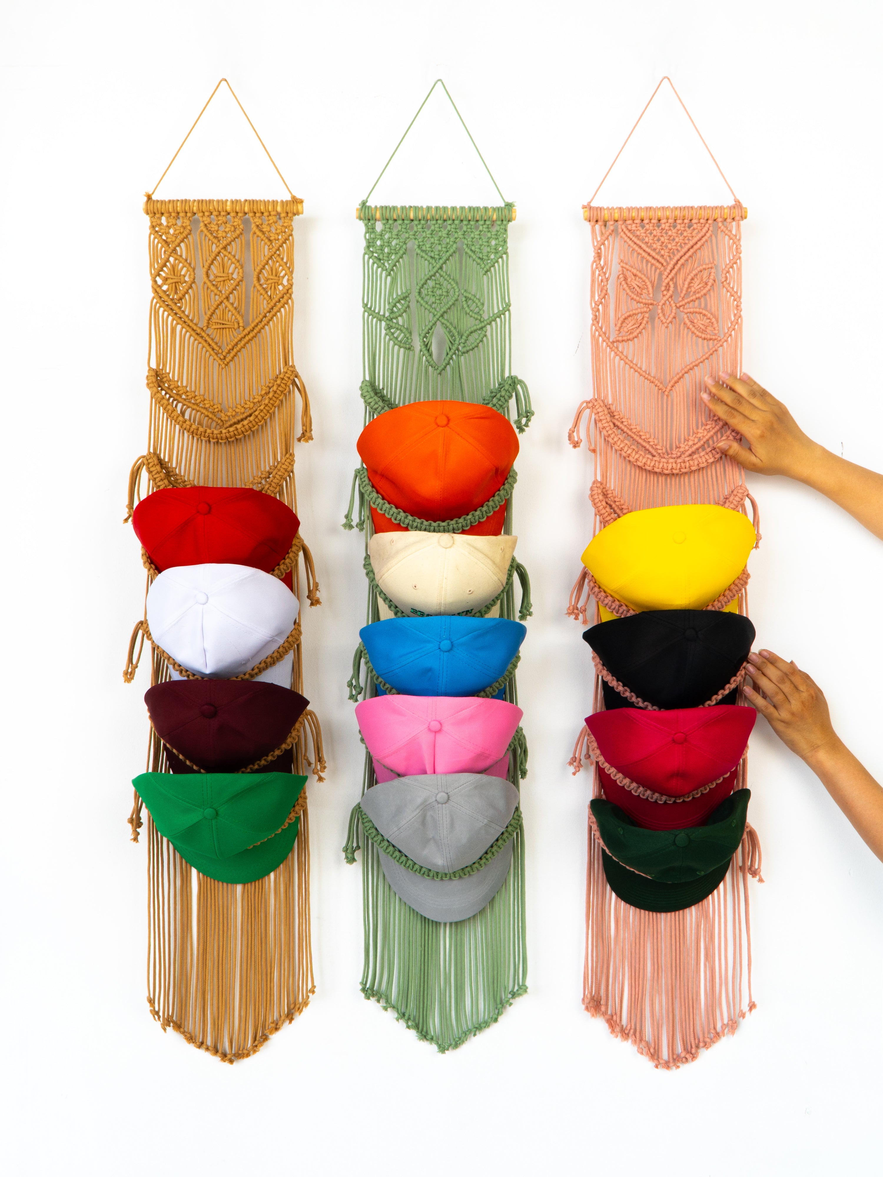 Colorful hat organizer with various colored hats on a white background