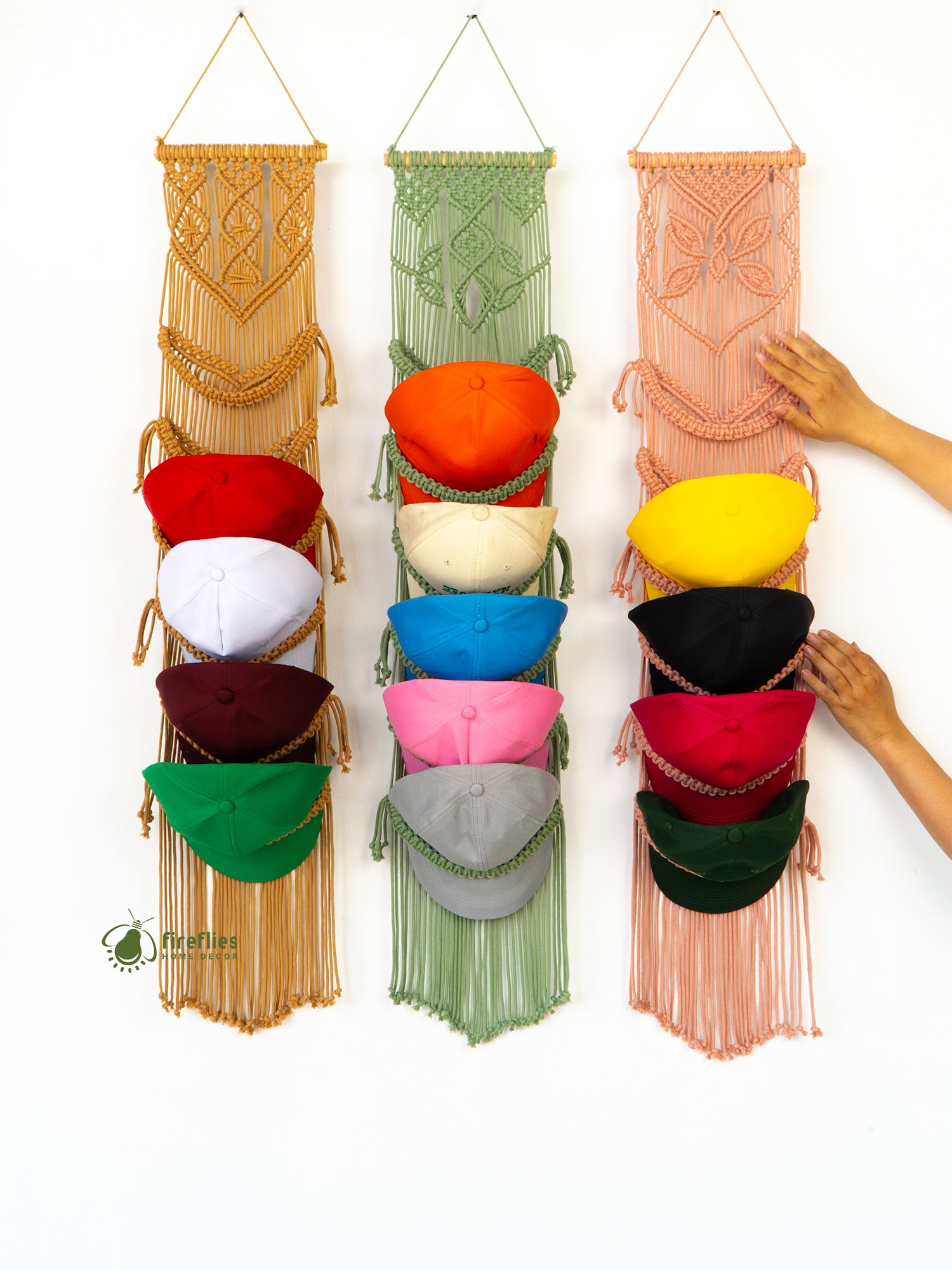 Three macrame wall hangings with colorful bags in different colors.