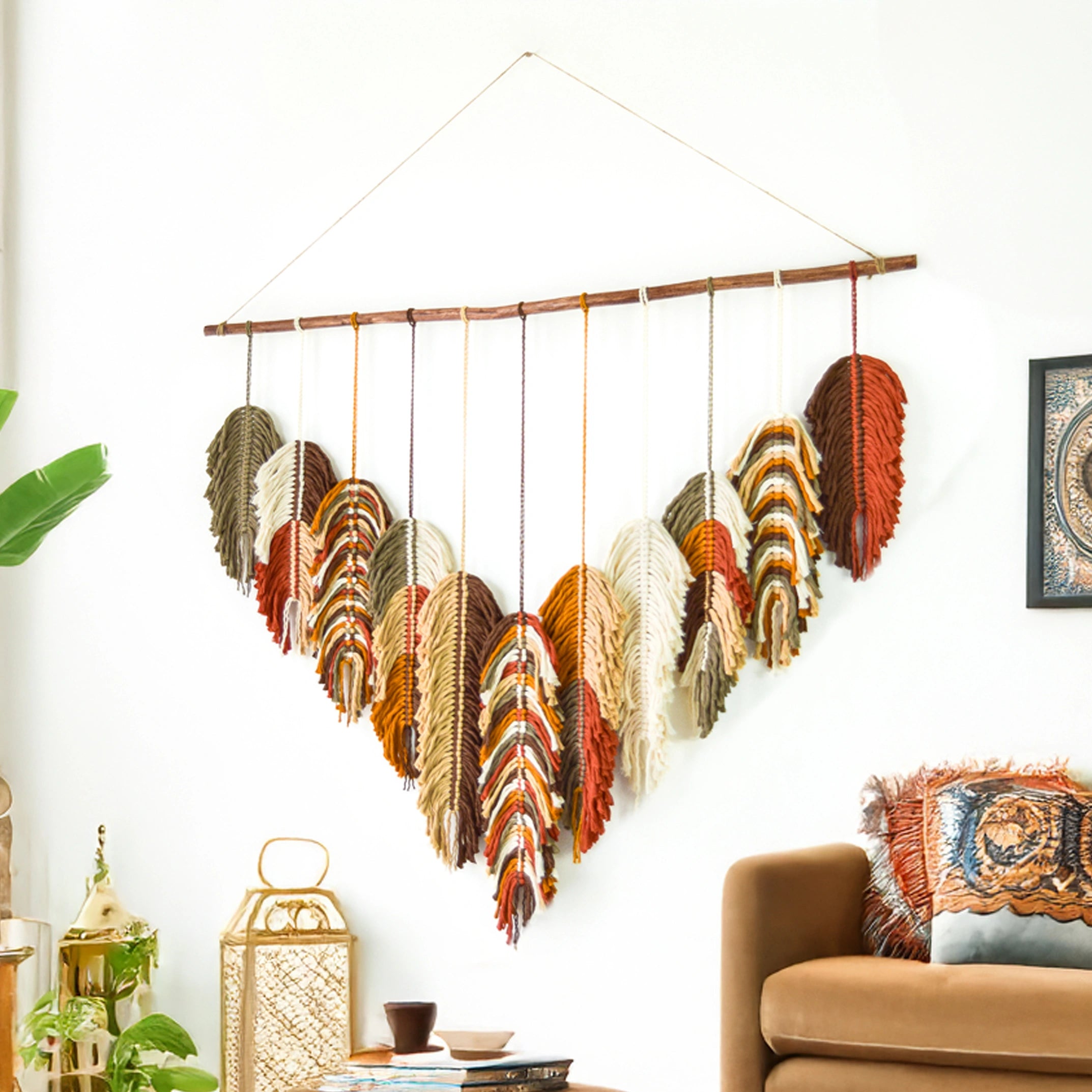 Colorful feather wall decoration on a white wall above a wooden headboard.