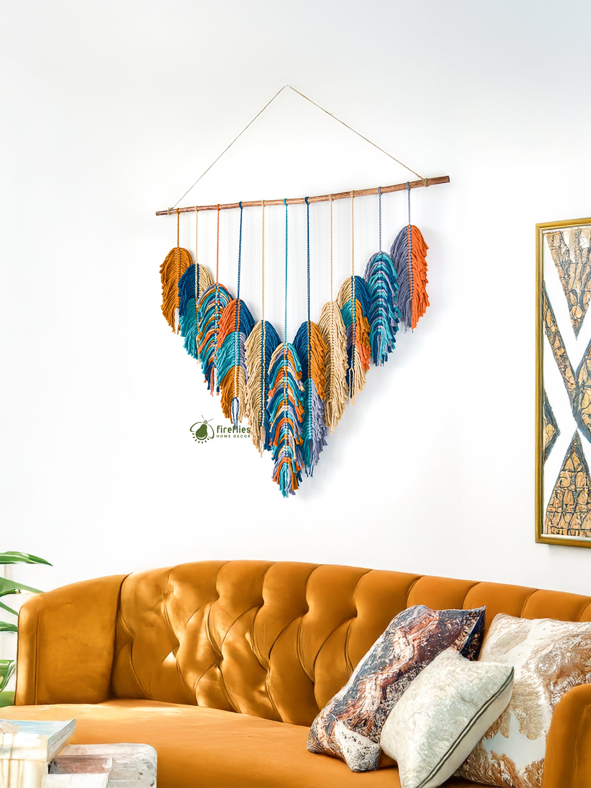 Colorful wall hanging above an orange sofa with decorative pillows.