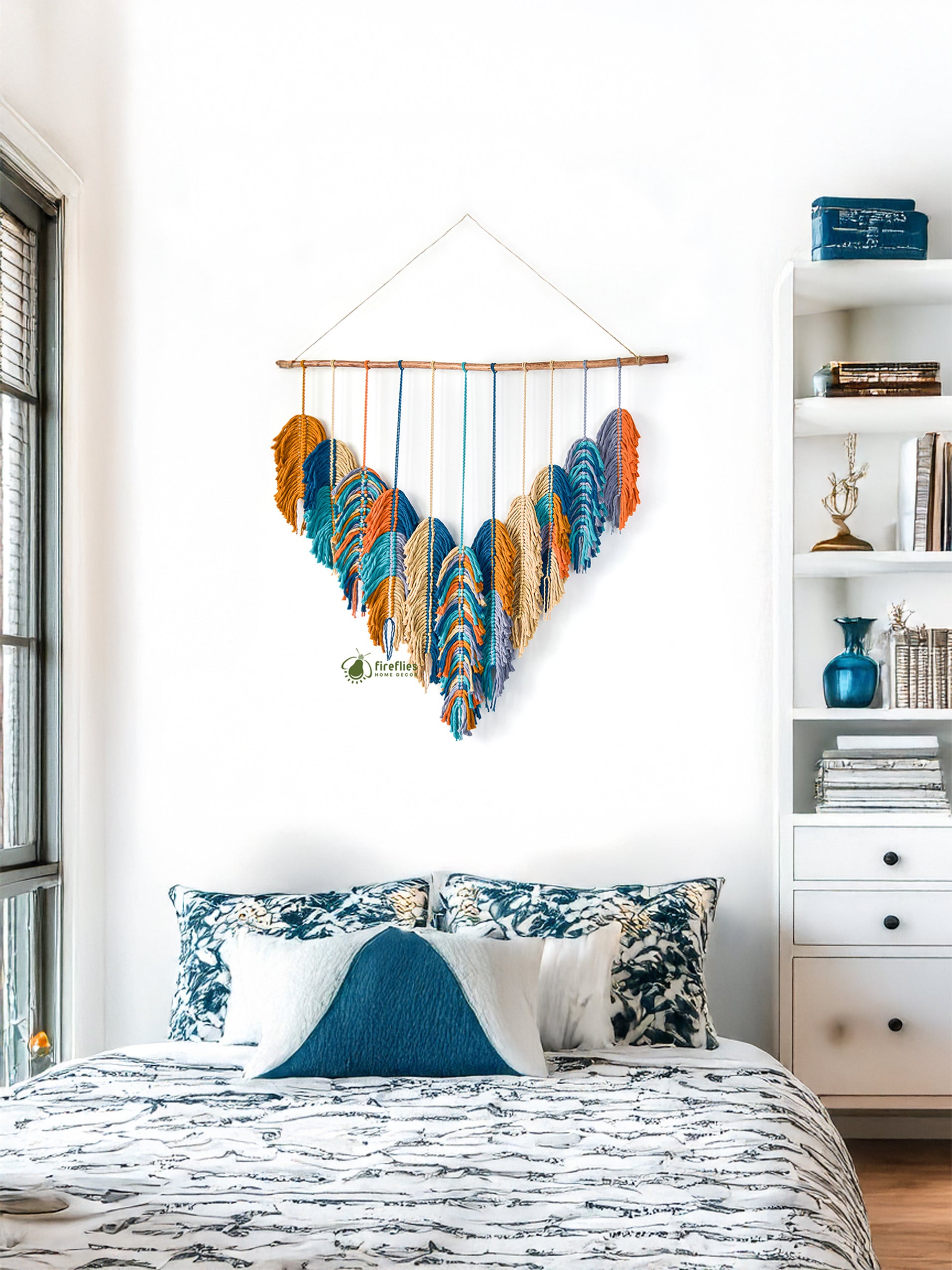Bedroom with colorful feather wall hanging above a bed