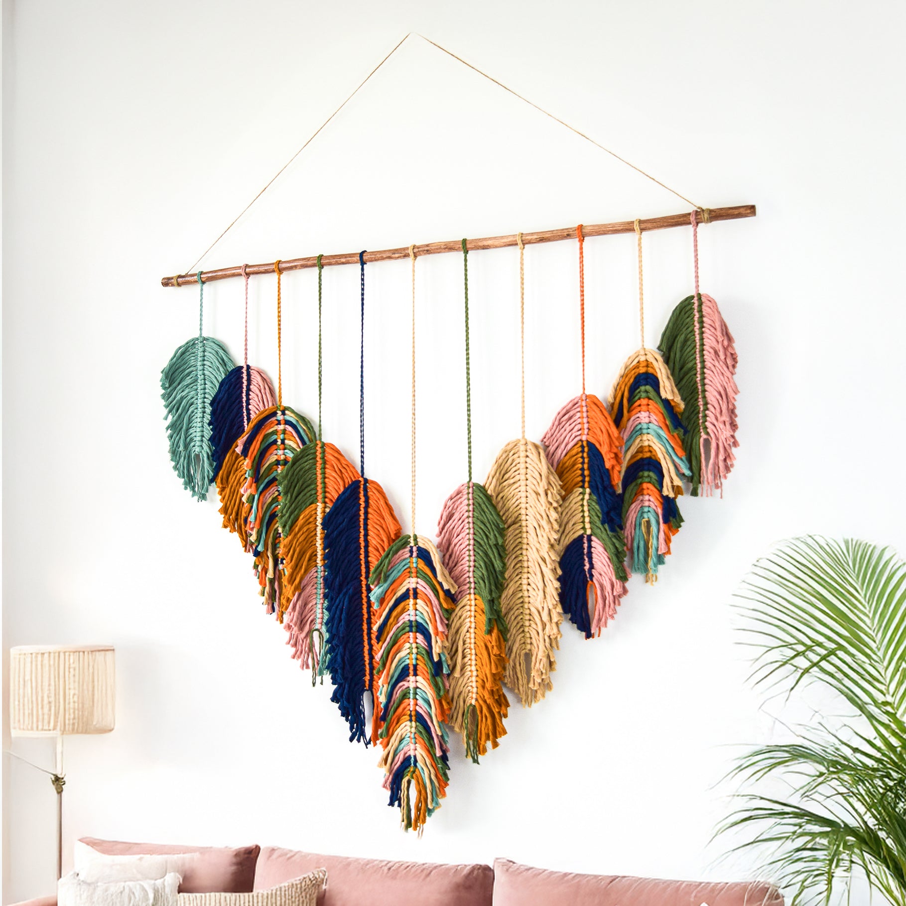 Decorative wall hanging with feathers in a living room setting