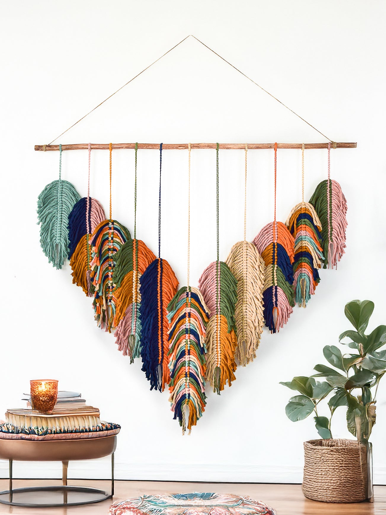 Woven wall hanging with feather designs in a living room setting
