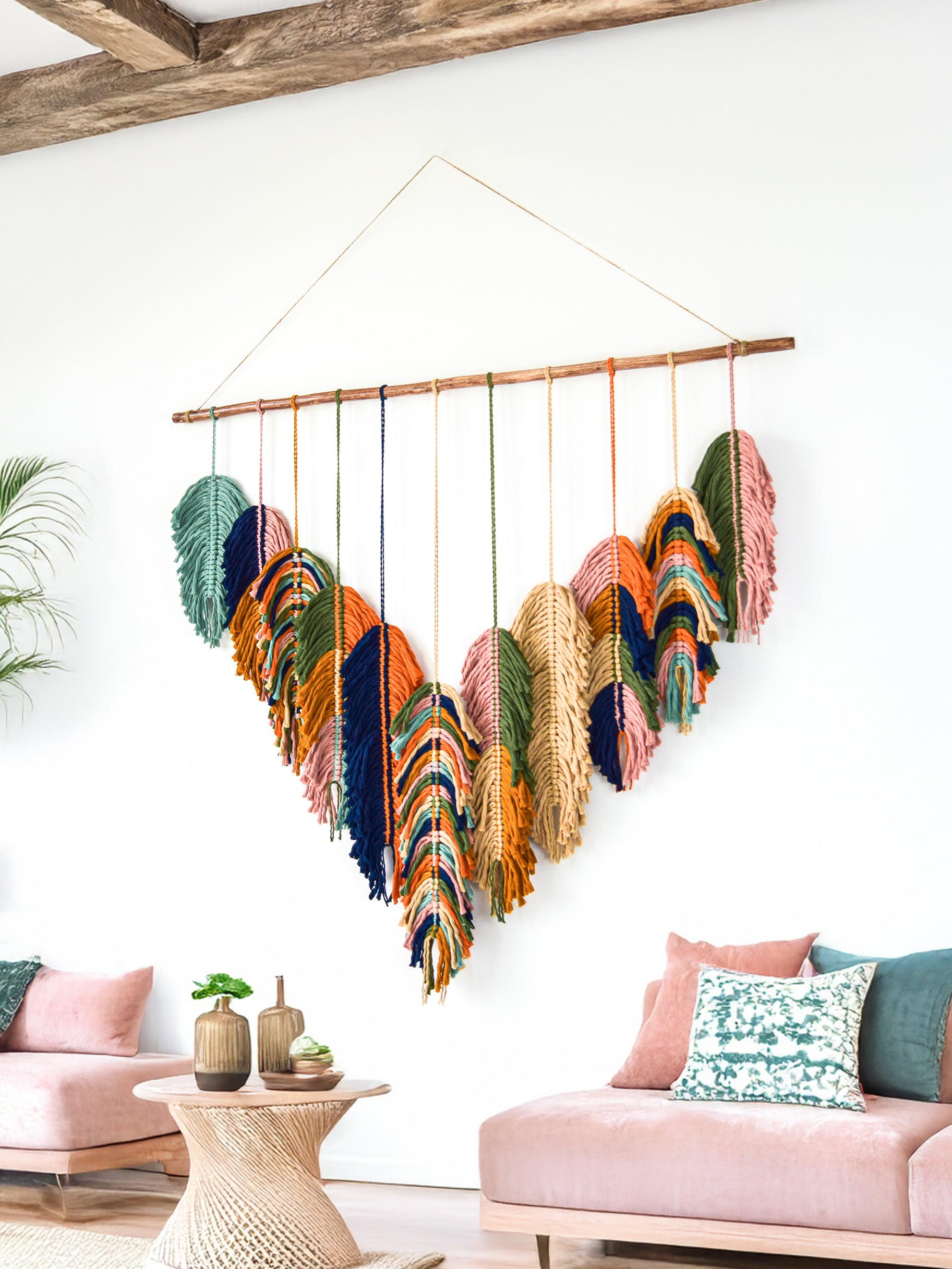 Decorative wall hanging with heart-shaped ornaments in a living room setting.