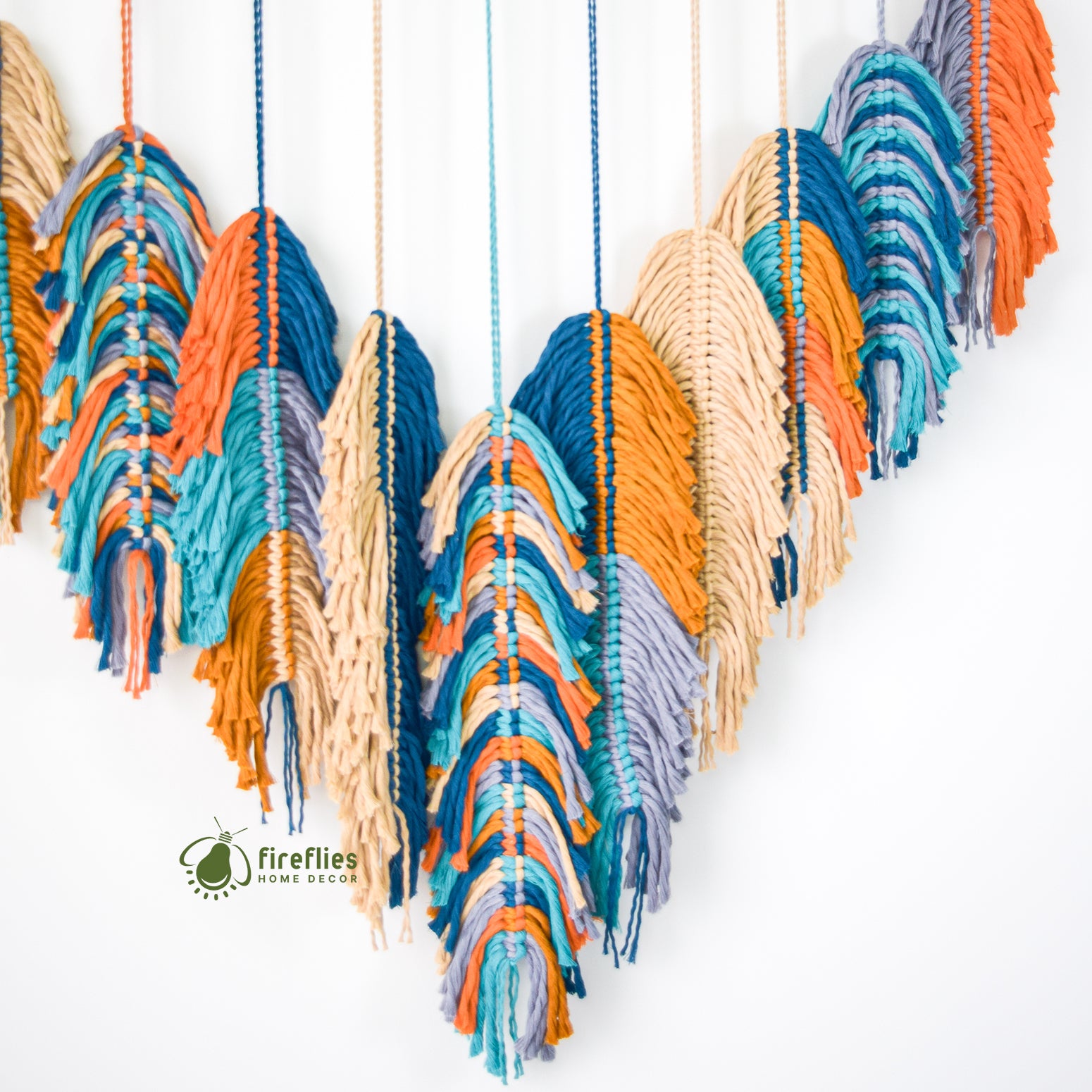 Colorful woven wall art with a 'fireflies home decor' logo on a white background