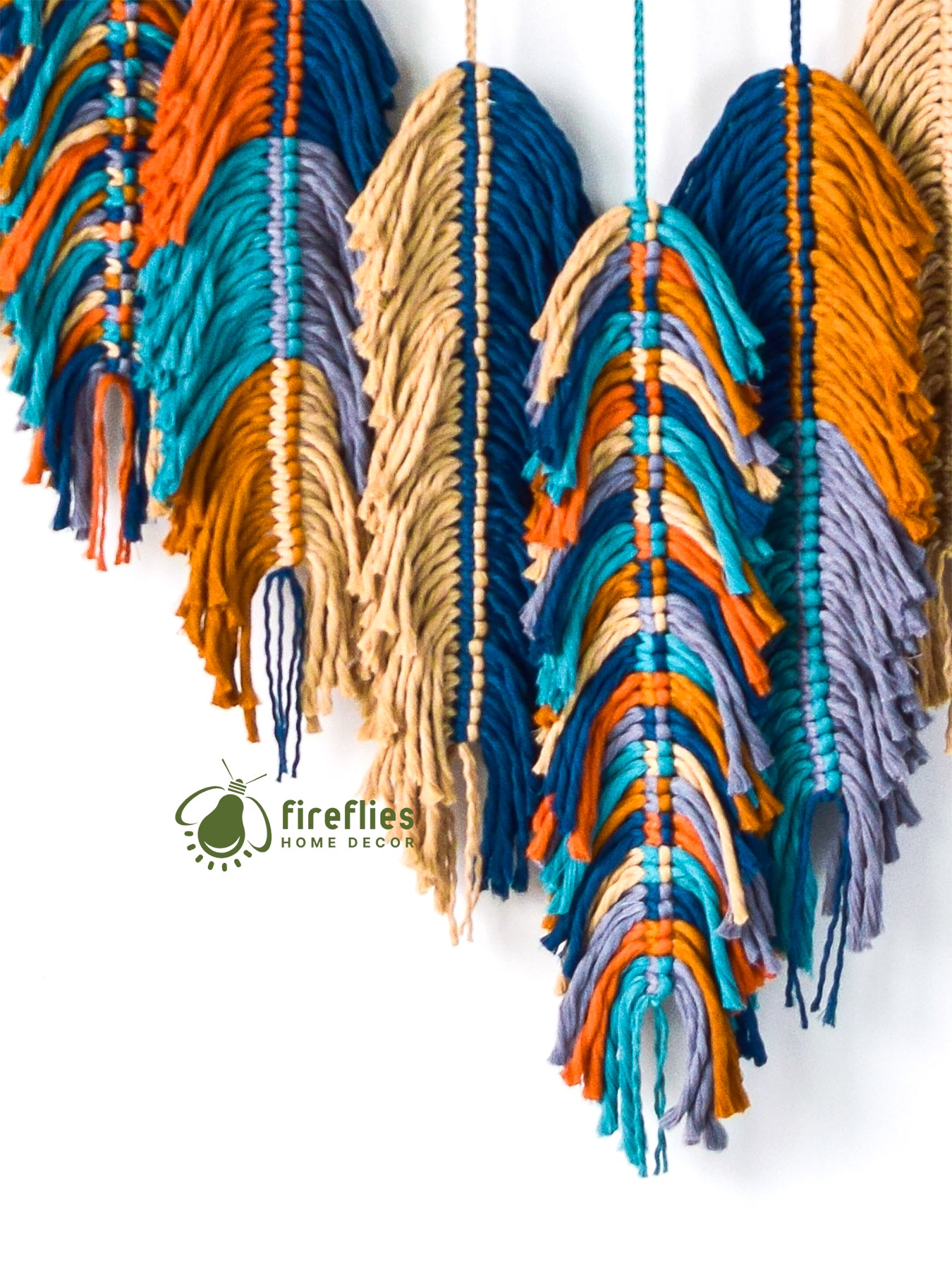 Colorful yarn wall hanging with 'fireflies home decor' logo.