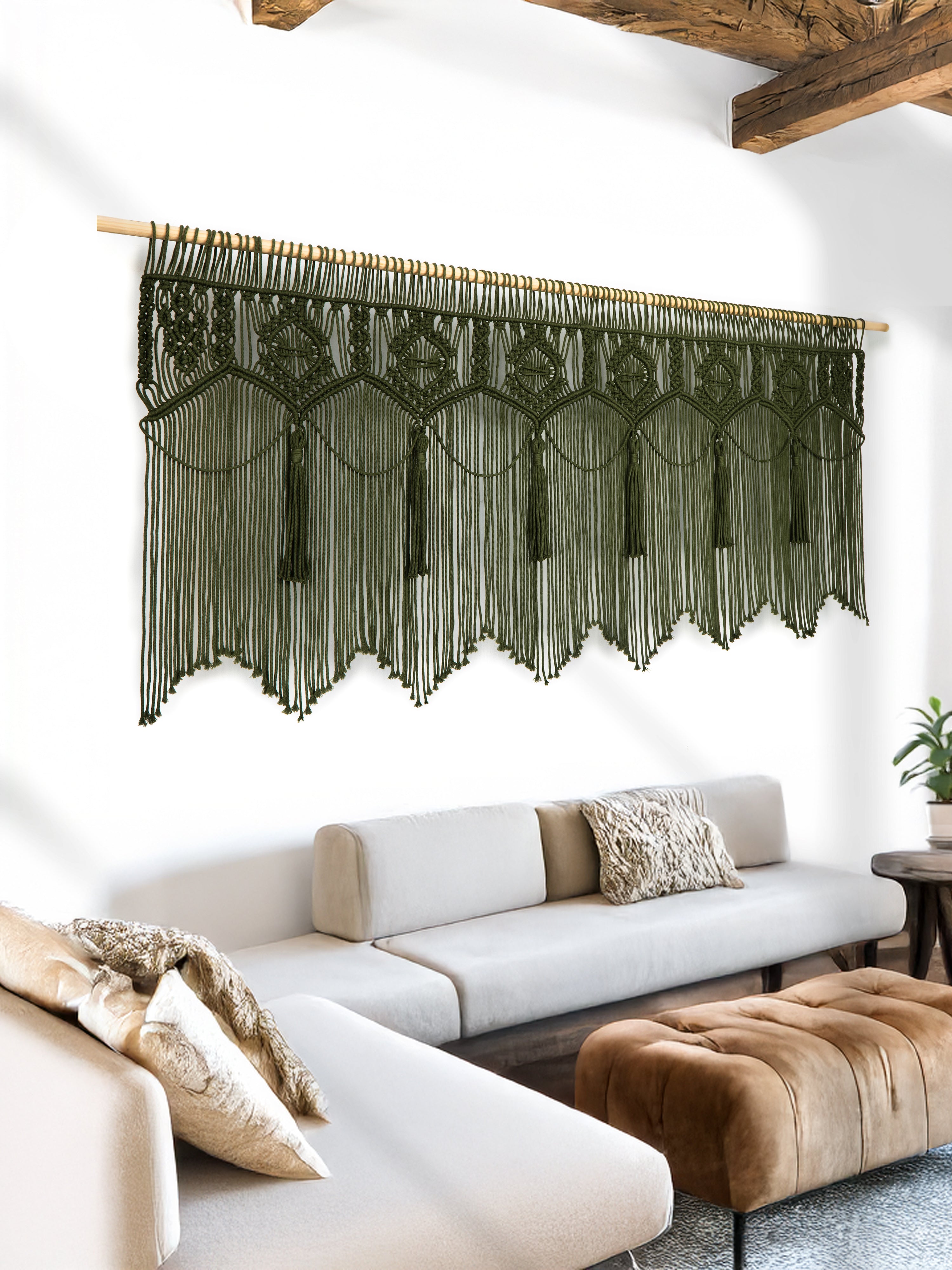 Woven wall art with colorful patterns on a white wall above a sofa.