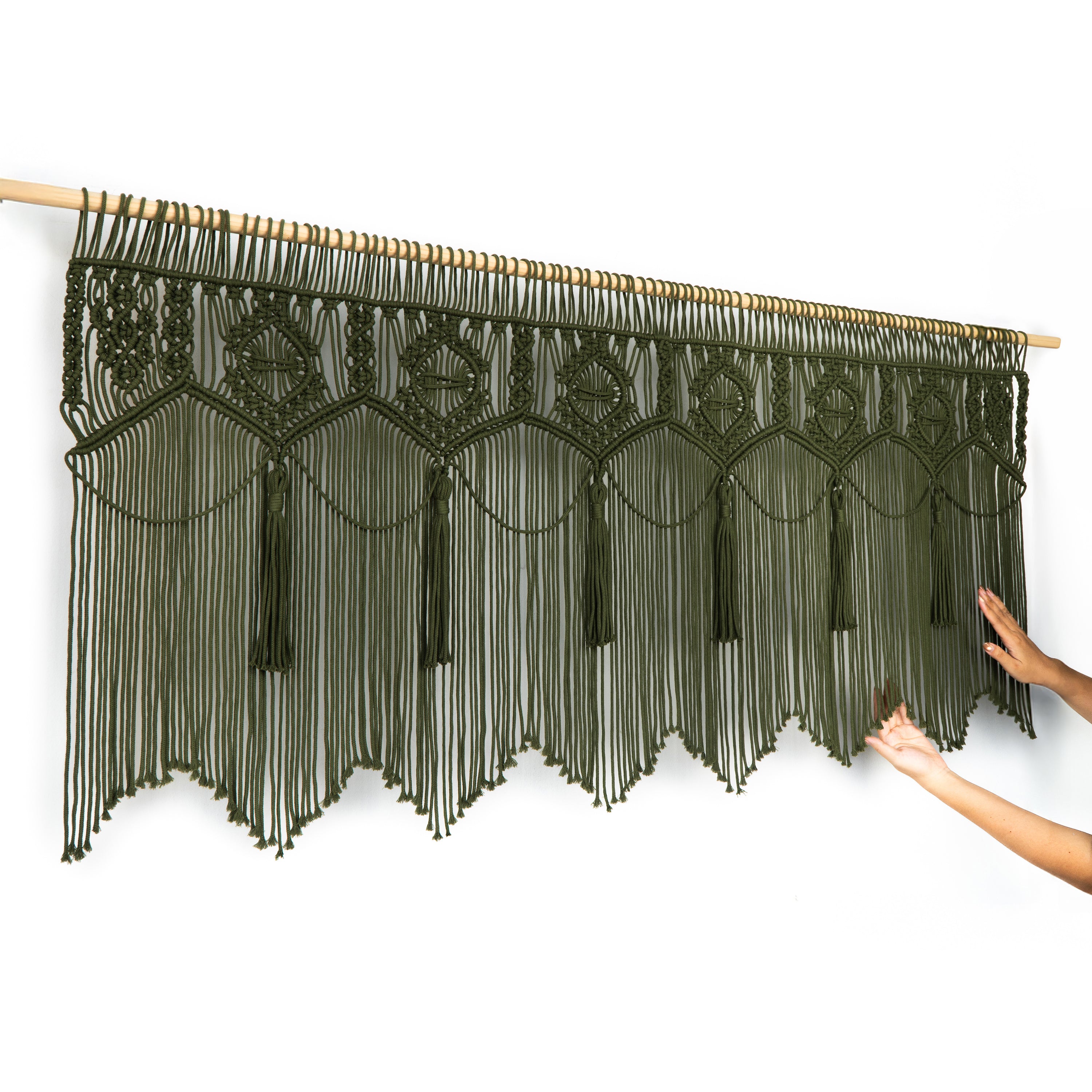 Decorative string curtain with geometric patterns on a white background