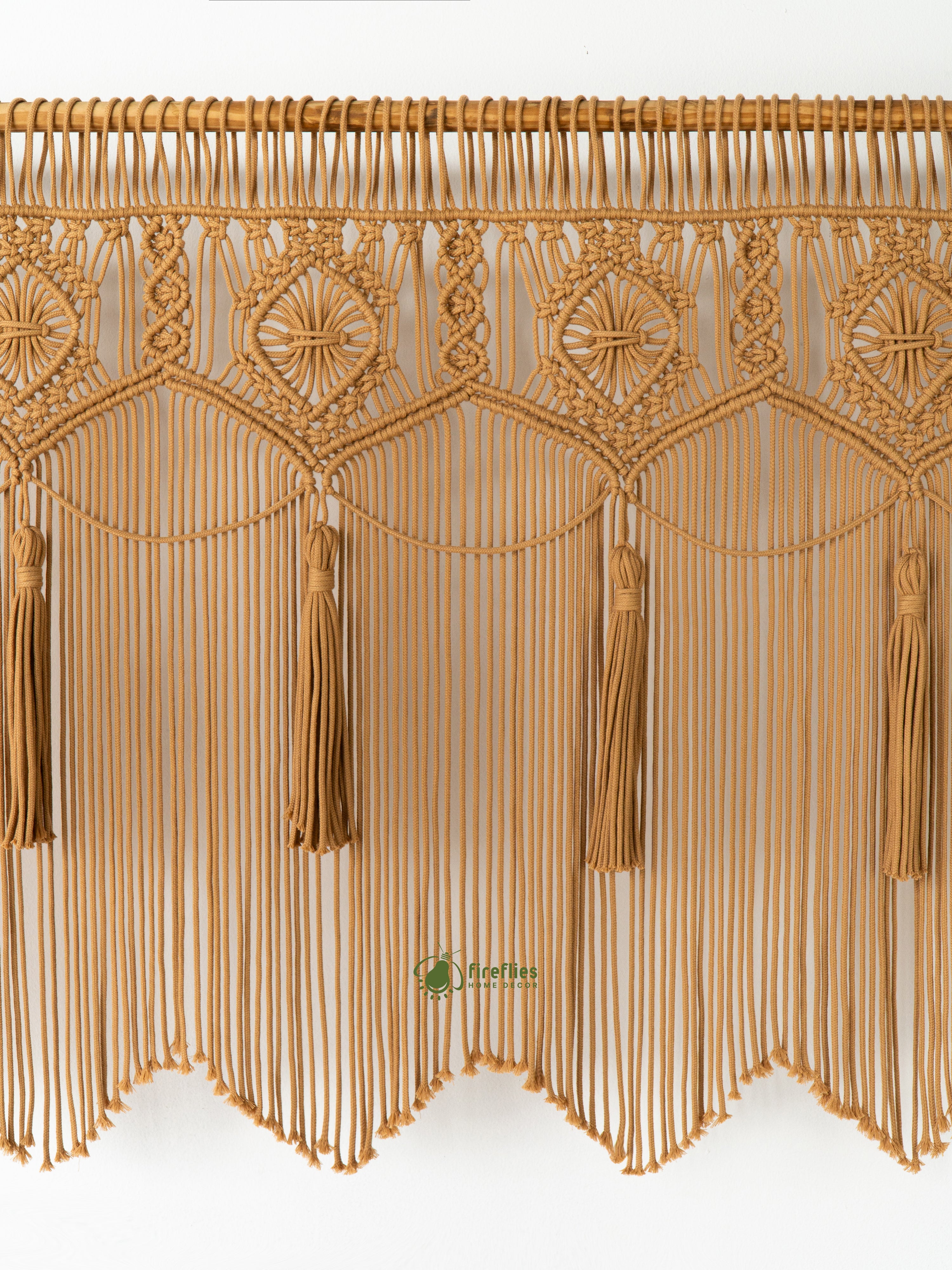 Decorative gold fringe with tassels on a white background